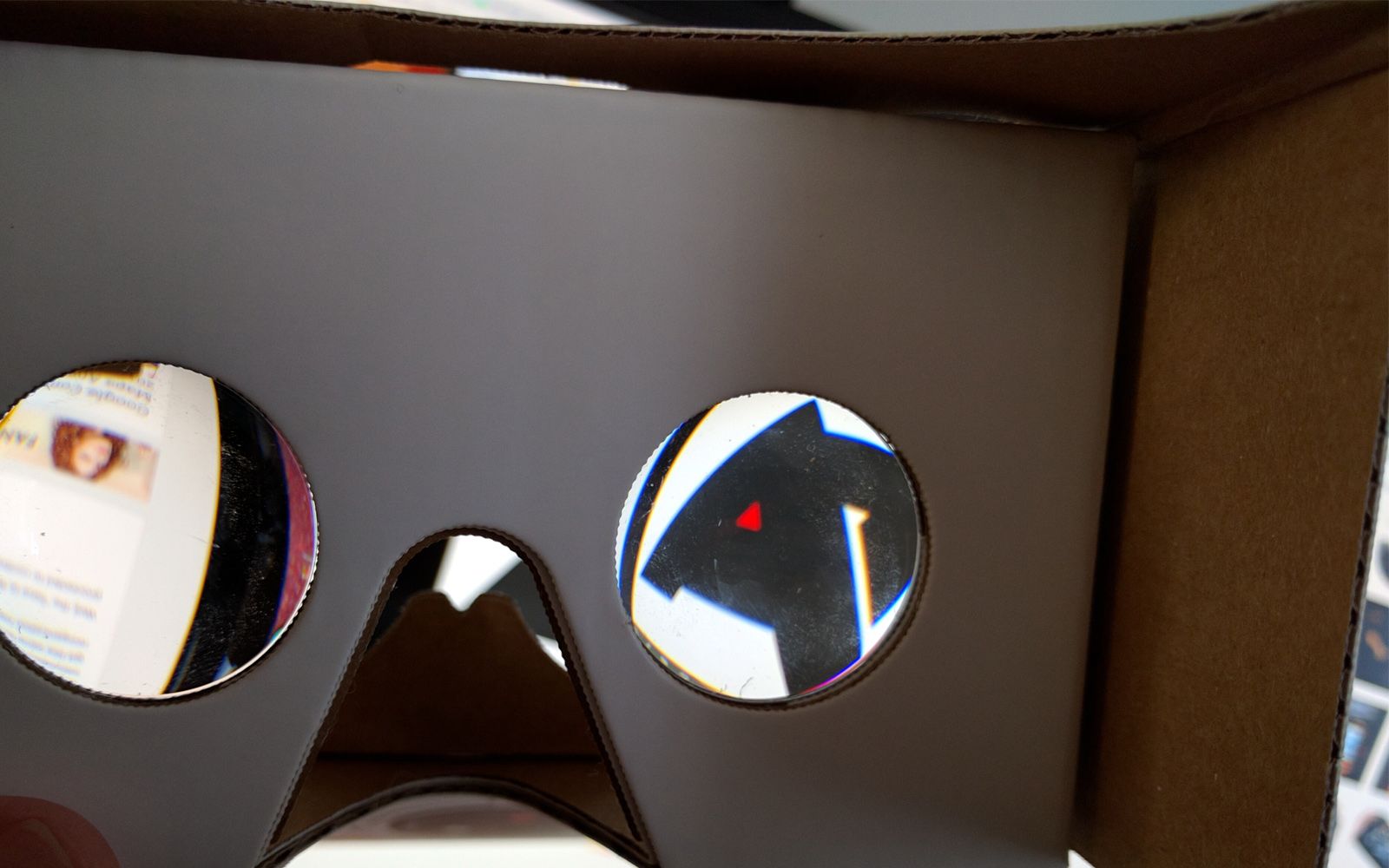 A look through the lenses of a Google Cardboard with the Android Police logo visible in the right eye