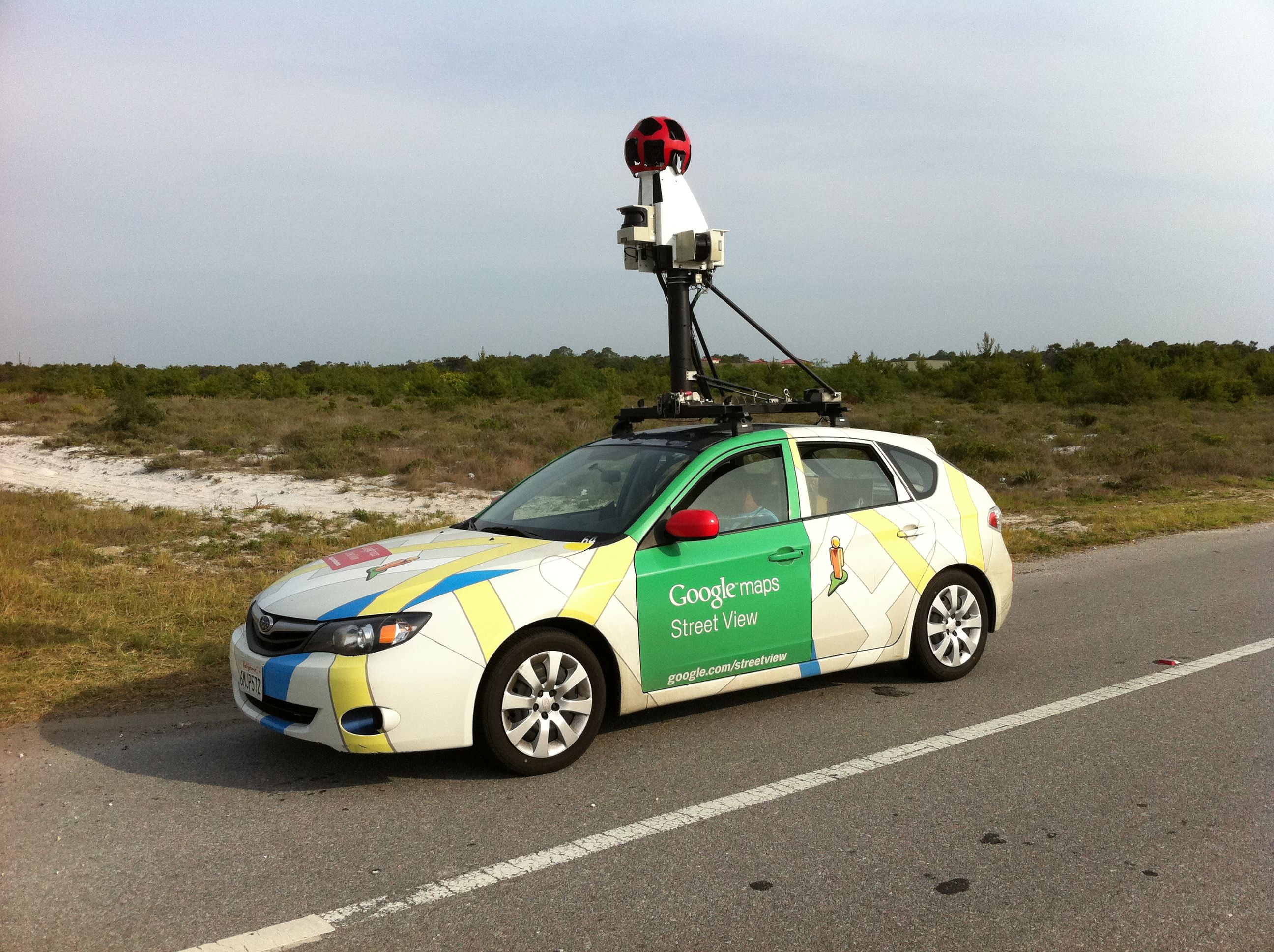A Google Street View vehicle on the side of the road in a rural area.