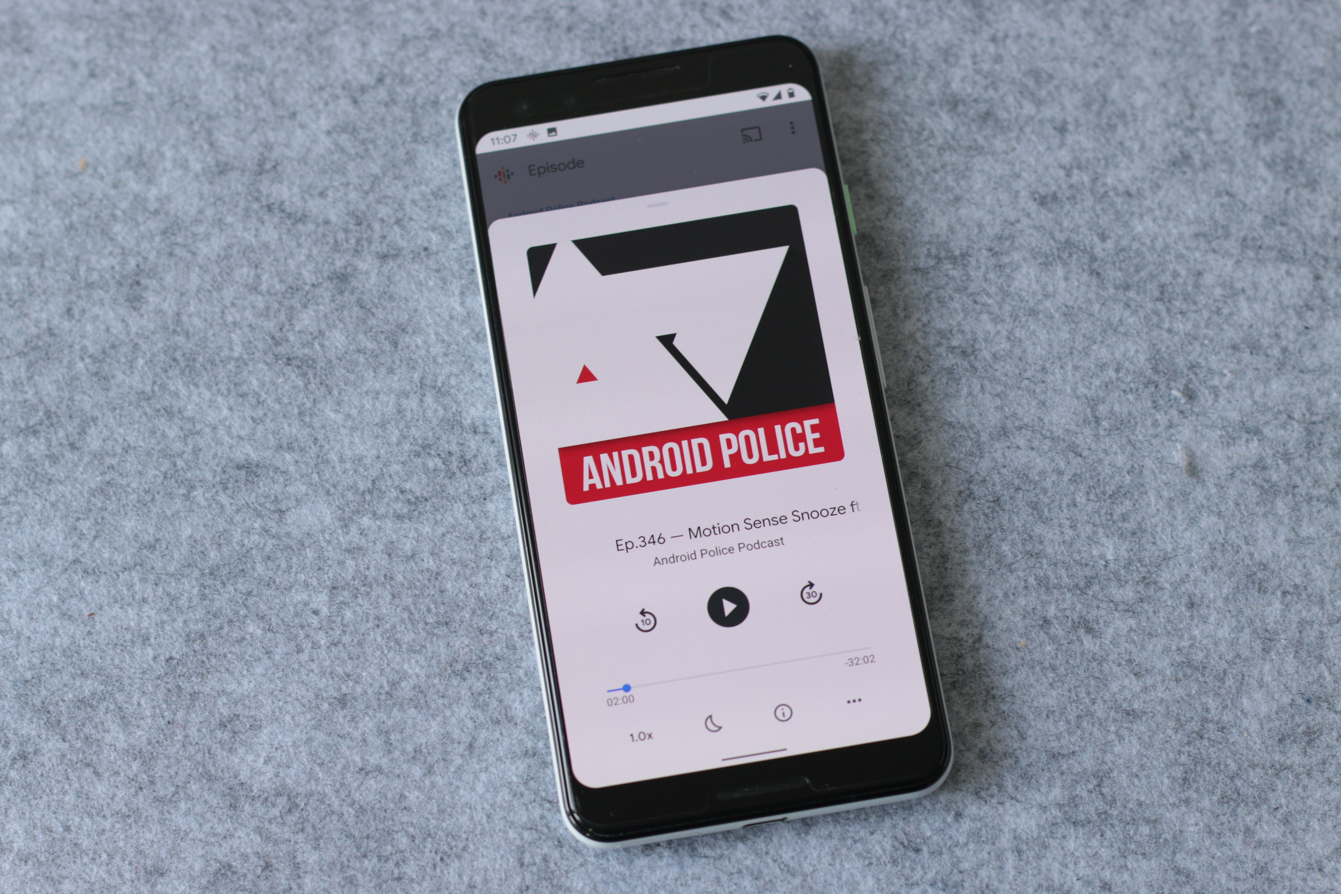 Google Podcasts on phone screen playing Android Police podcast