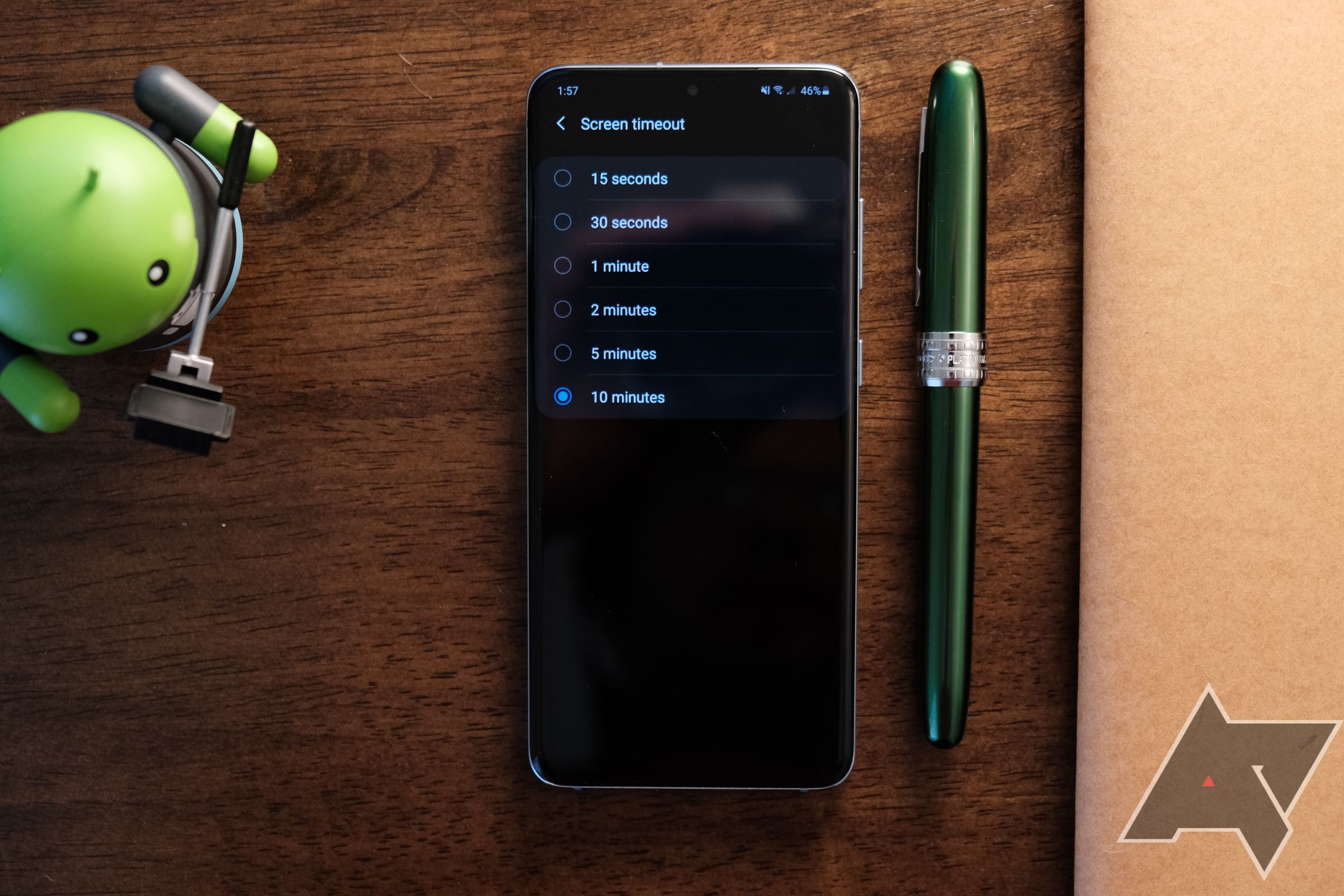 A smartphone on a desk showing a settings screen.