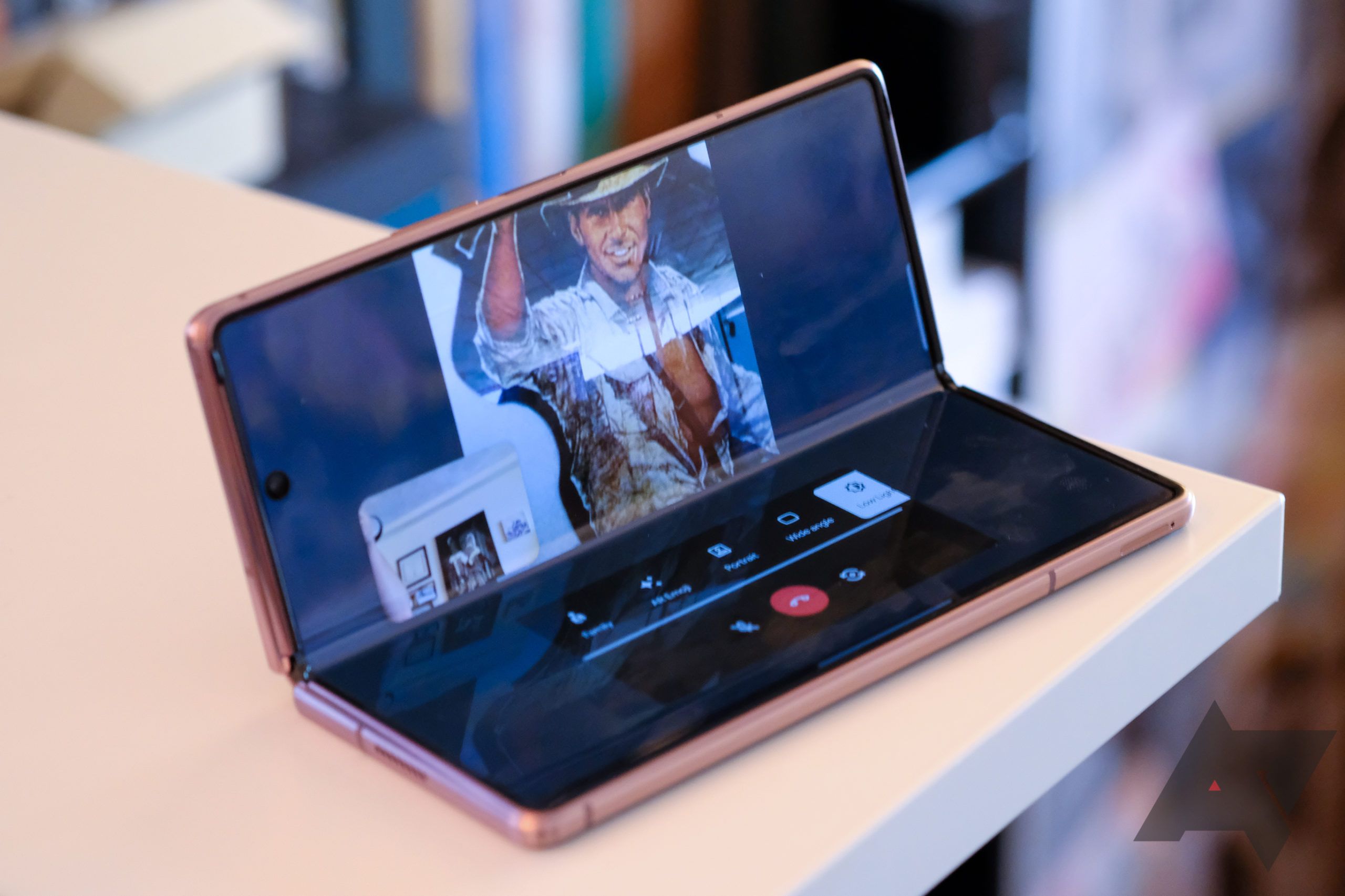 A Samsung Galaxy Z Fold 2 Duo sitting on a table and playing a movie