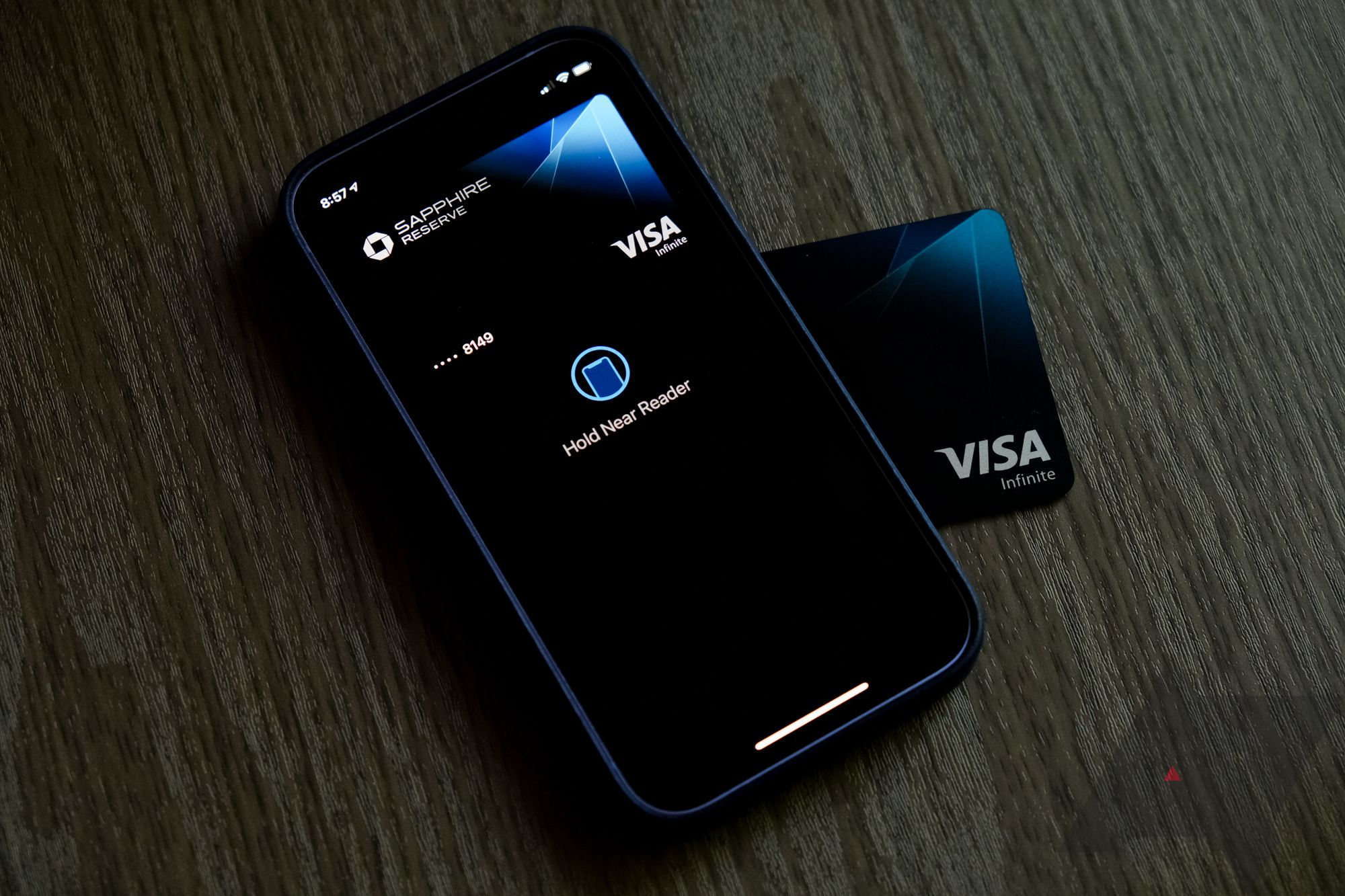A visa card and iPhone showing the Apple Pay system. 