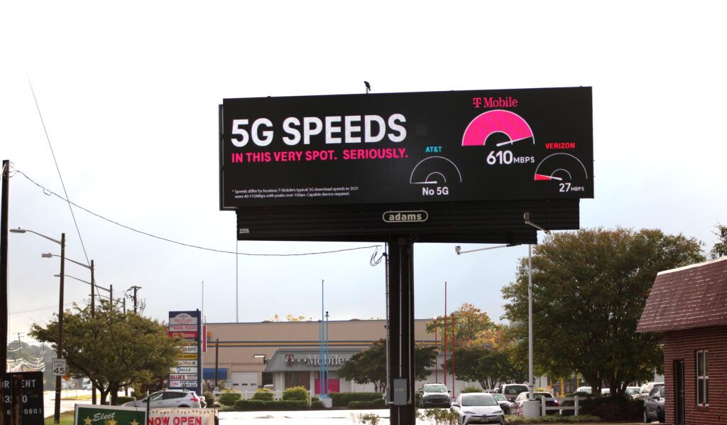 T-Mobile live mobile data speeds billboard in front of T-Mobile store