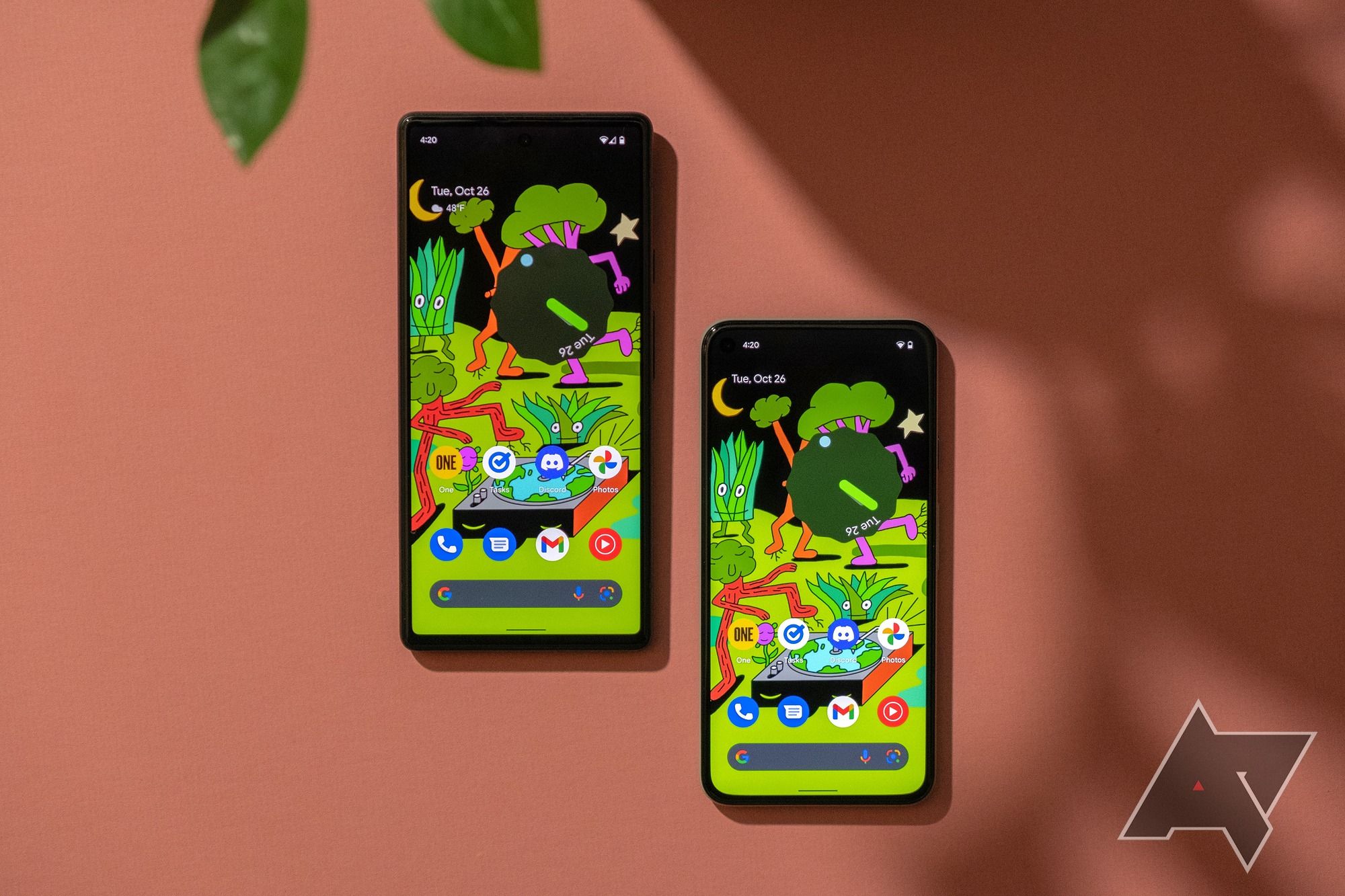 The Google Pixel 5 and Pixel 6 against an orange background