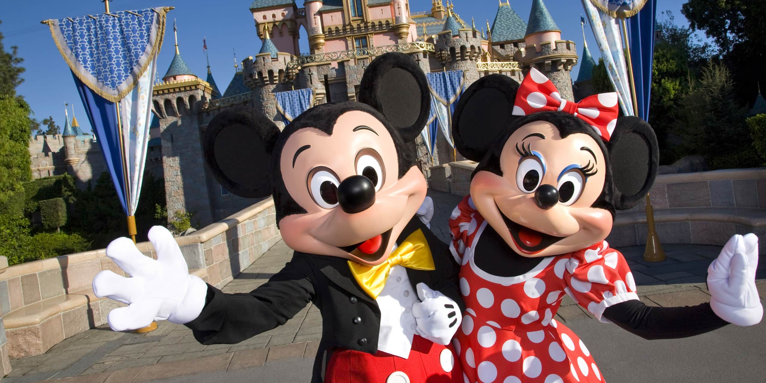Mickey and Minnie Mouse in front of castle