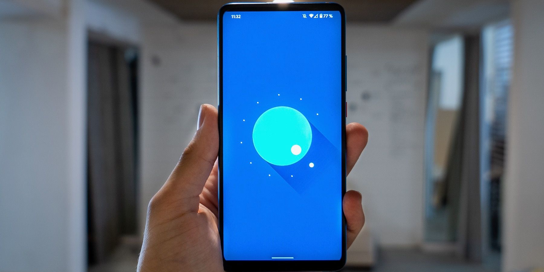 hand holding android phone showing blue screen