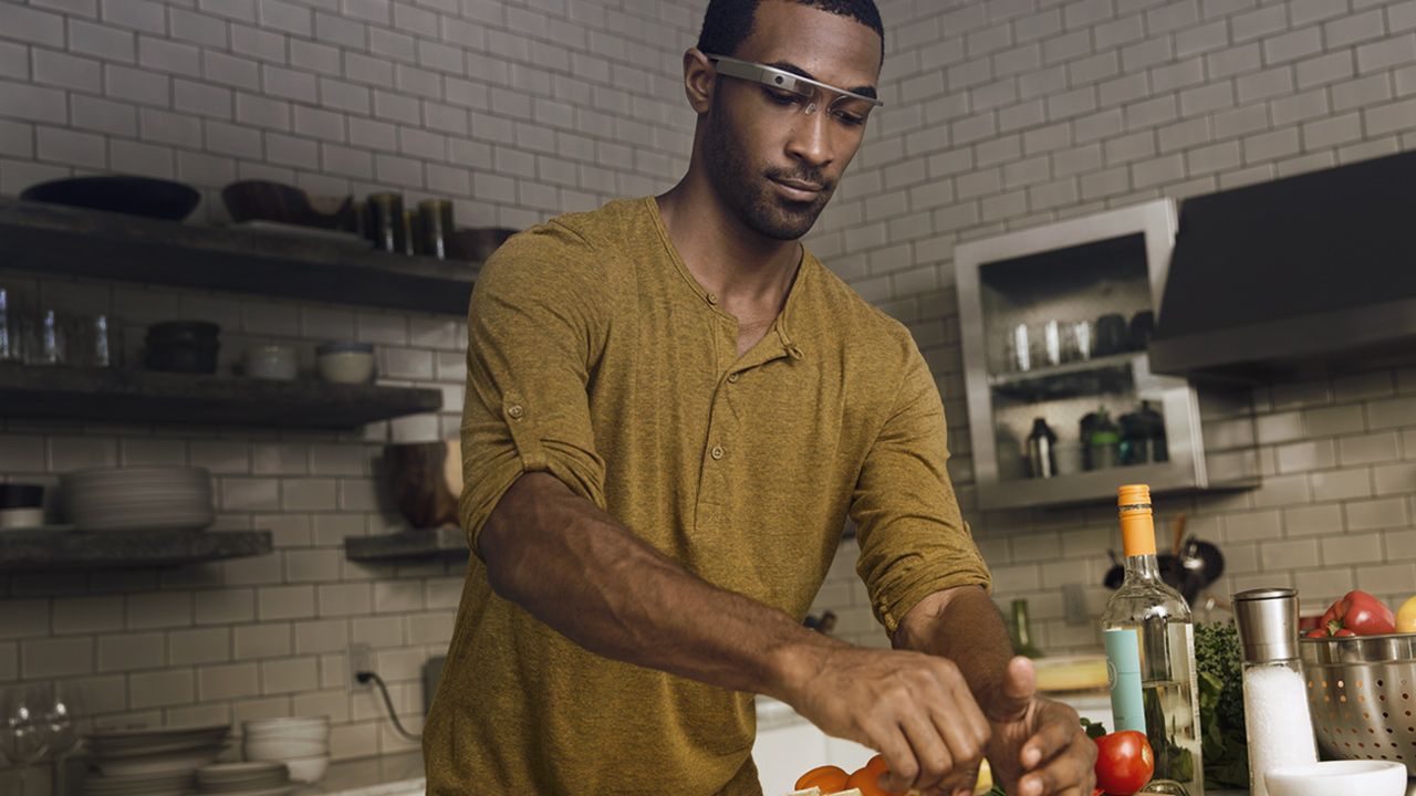 A man using Google Glass while cooking in the kitchen
