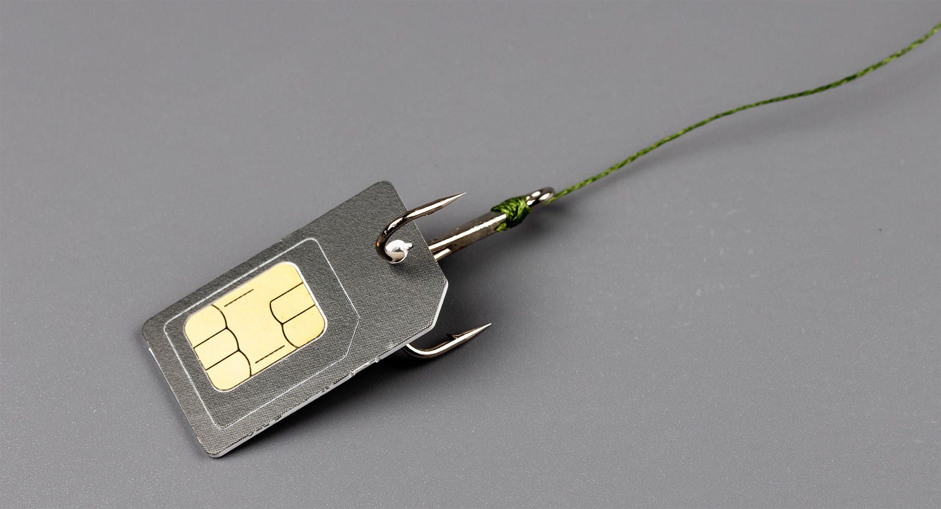 A SIM card attached to a fishing hook. 