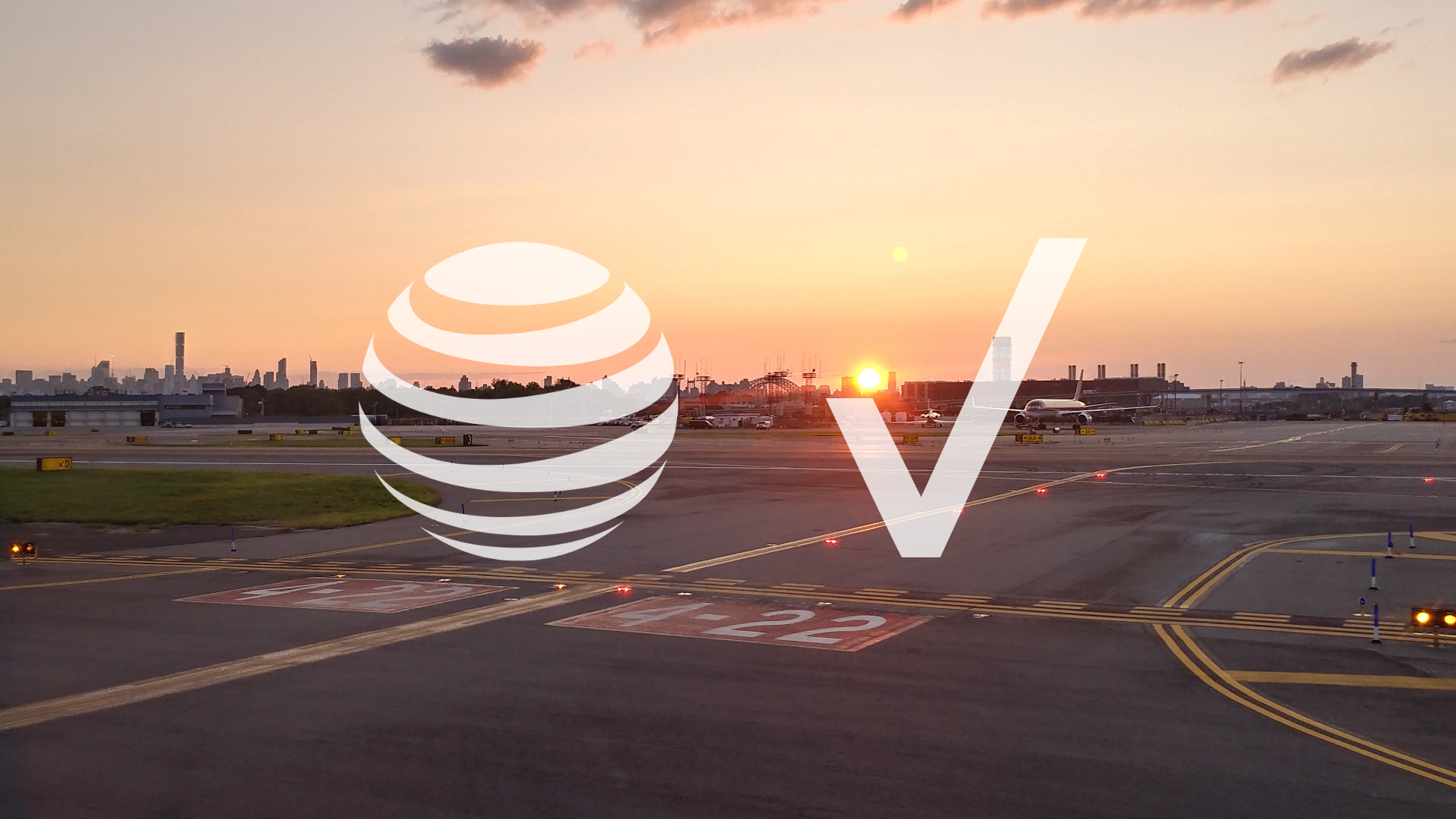 AT&T and Verizon Wireless logos overlayed on top of an airport runway