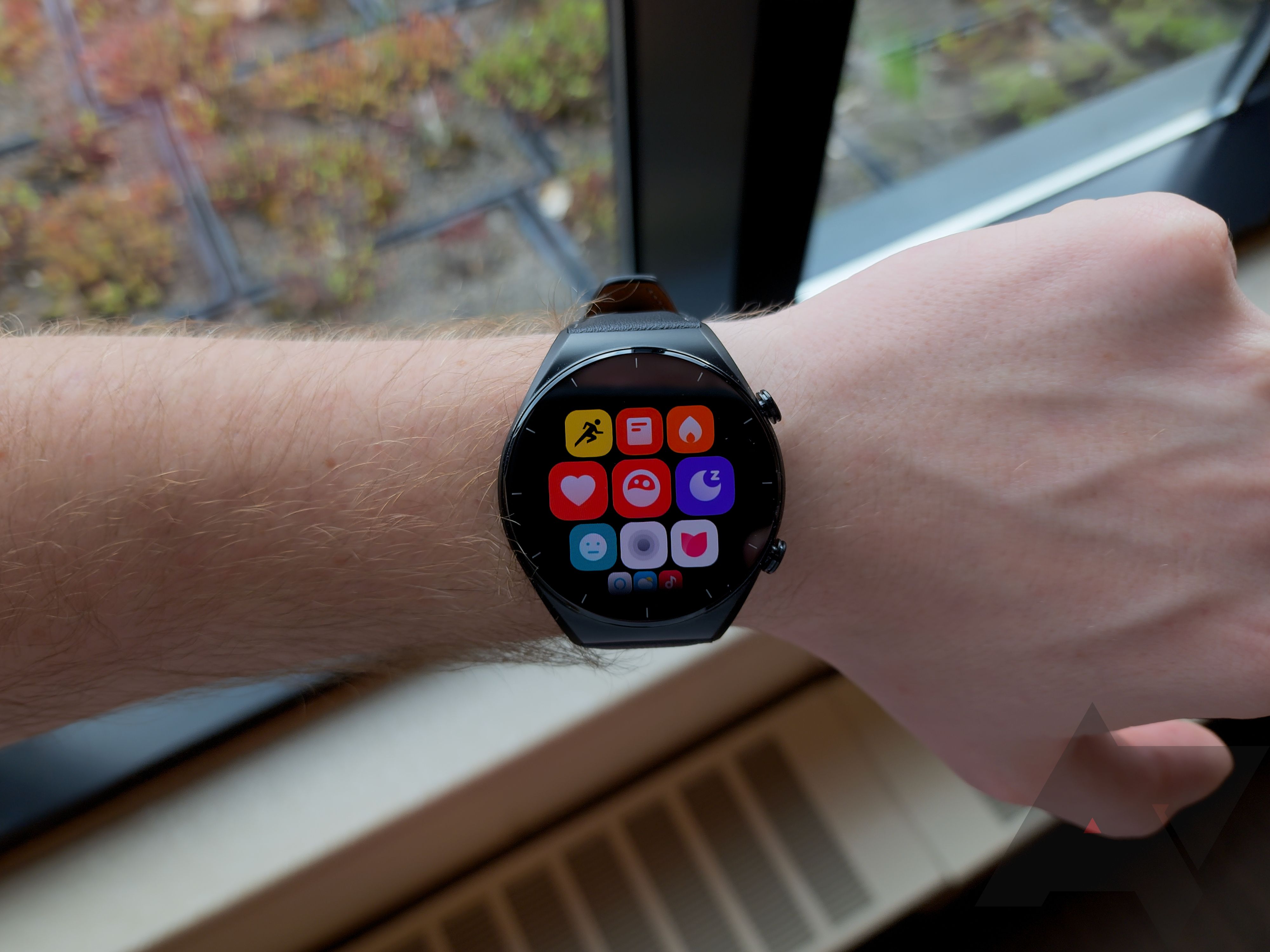 A smartwatch showing several app icons.