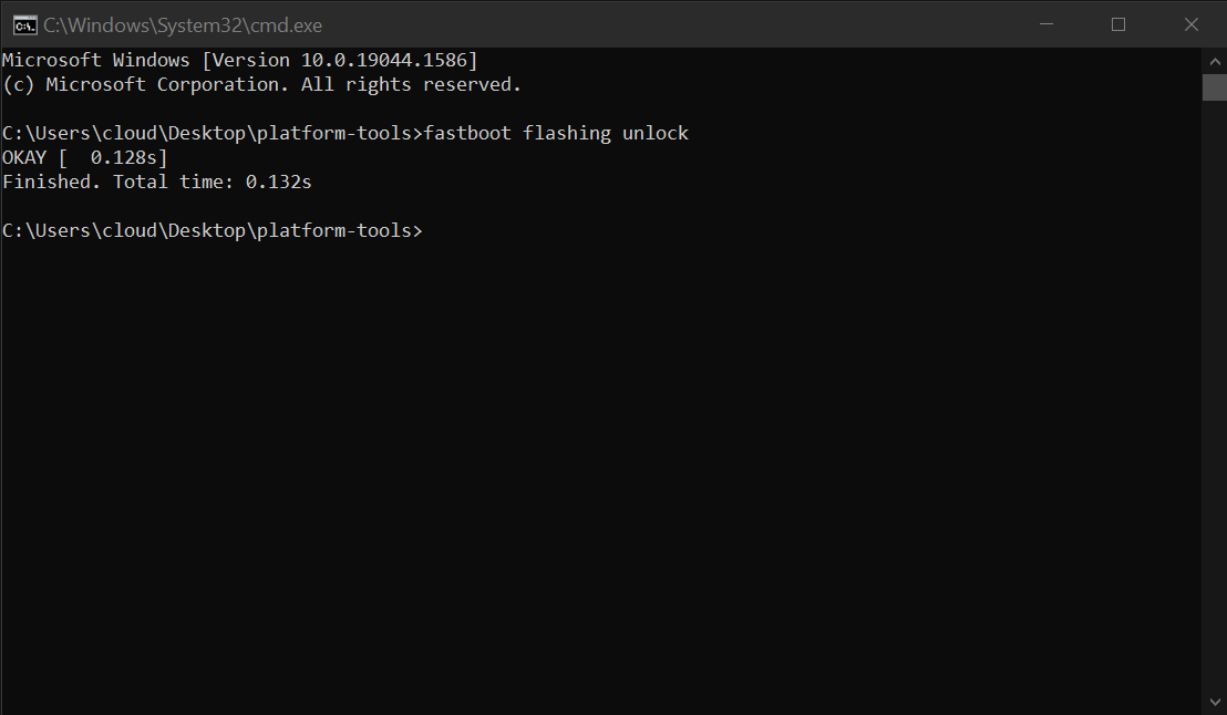 Running the "fastboot flashing unlock" command in a Windows command prompt.
