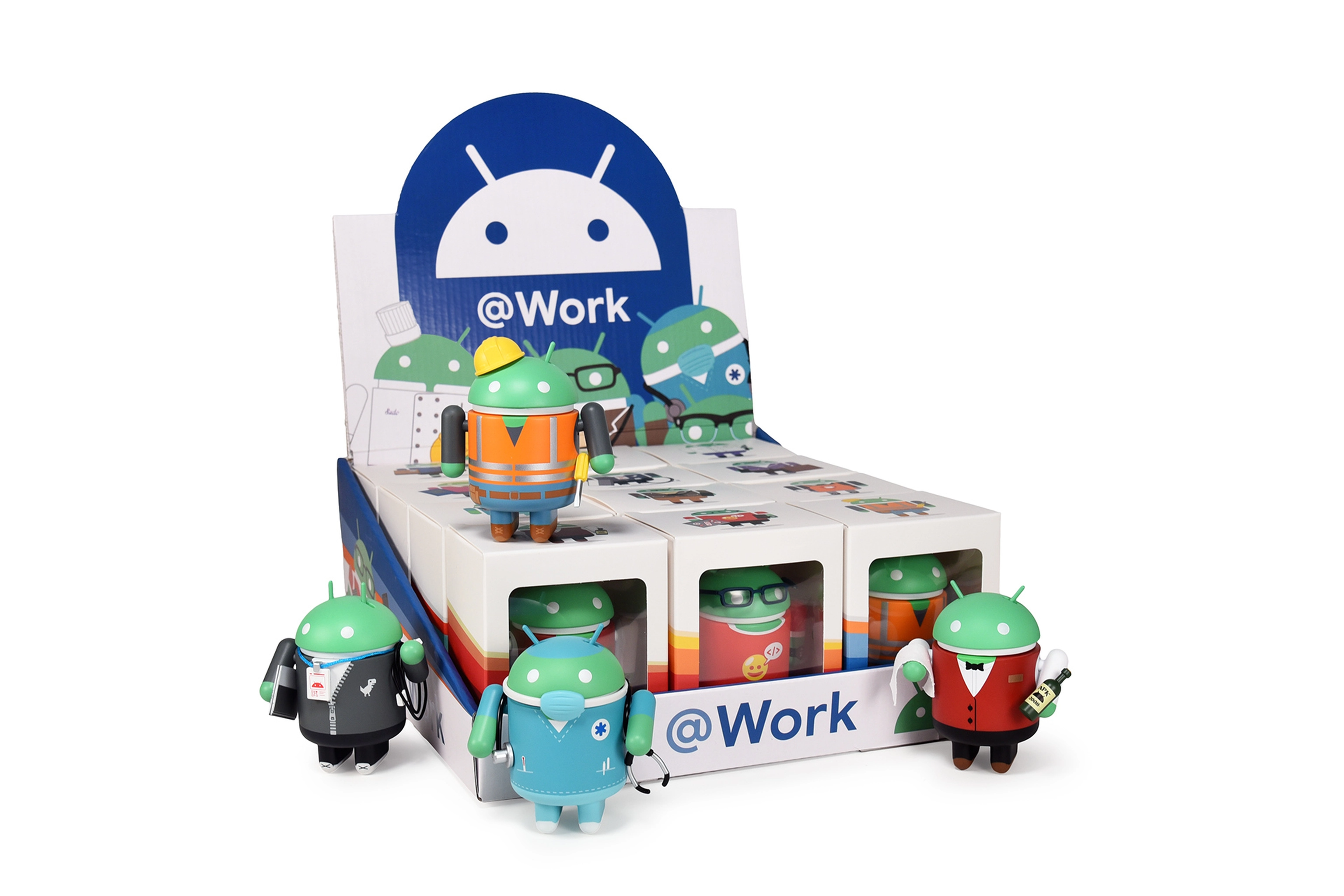 An image of 12 boxed bugdroid figurines in a tray. The toys are dressed as workers in different occupations and are part of the '@Work' collection from studio Dead Zebra