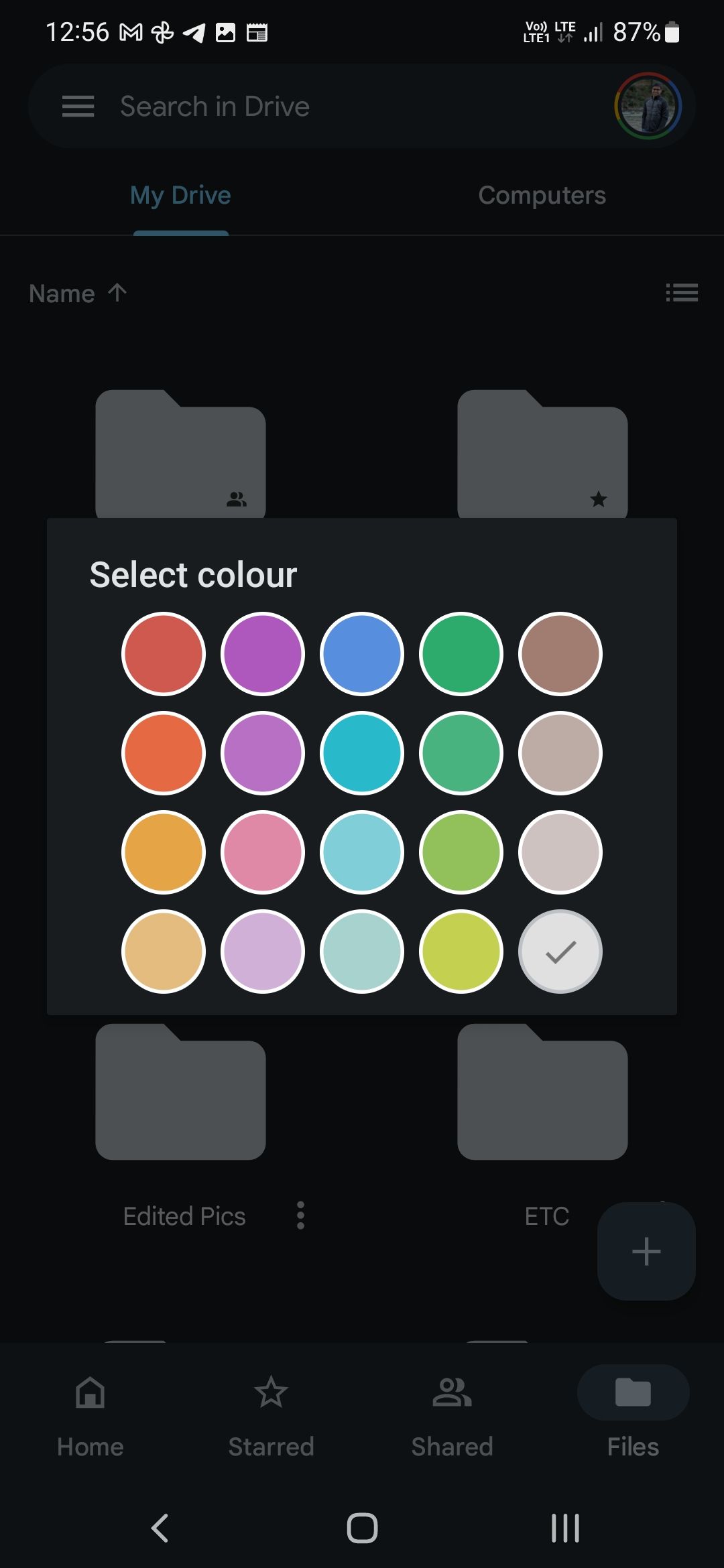 A screenshot depicting Google Drive's color picker window, used for choosing folder colors. The window shows various color options, with a neutral white color currently highlighted as the selected choice for a folder.