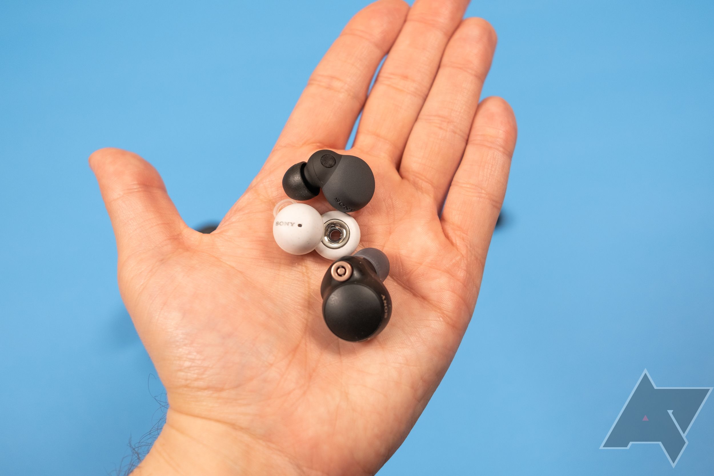 Sony LinkBuds S, LinkBuds, and WF-1000XM4 in a person's hand.