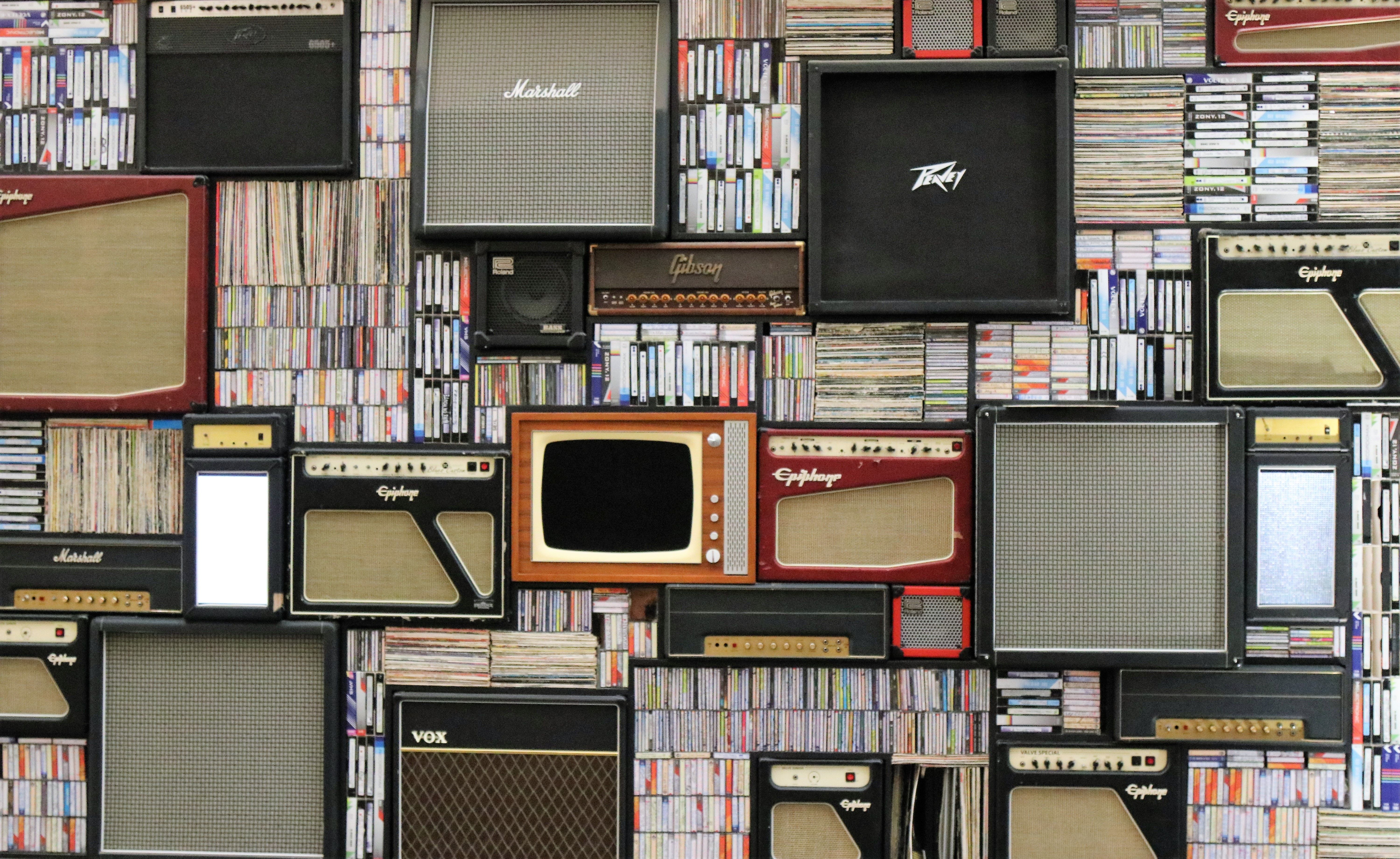 televisions and speakers against a wall of books
