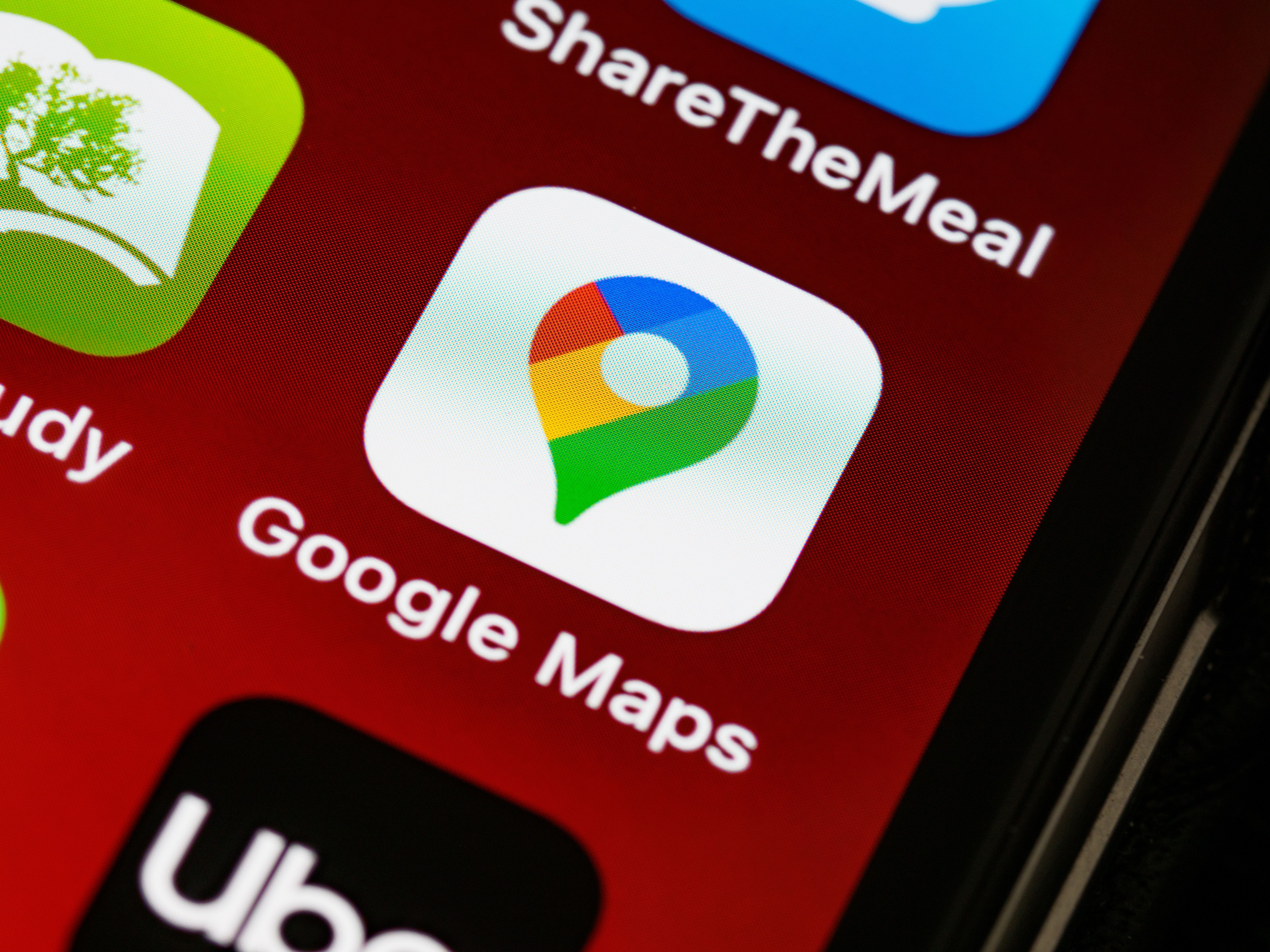 Edge of smartphone display with Google Maps icon in focus