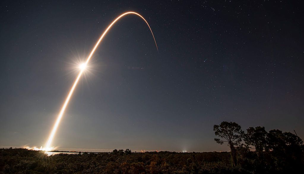 Trajectory of a SpaceX rocket launch shown at nighttime. 