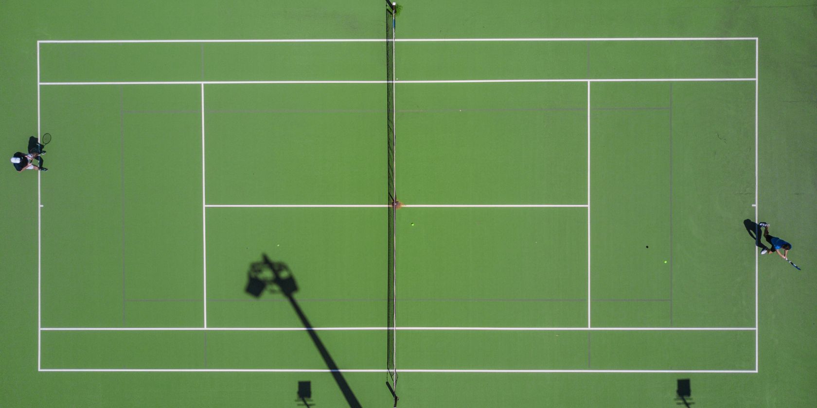 two people playing tennis