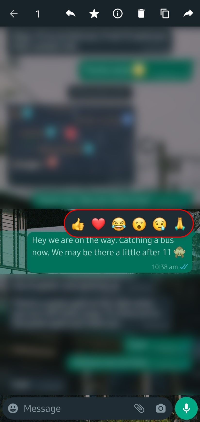 whatsapp chat with a reaction pop-up with several emoji available to react to the message with