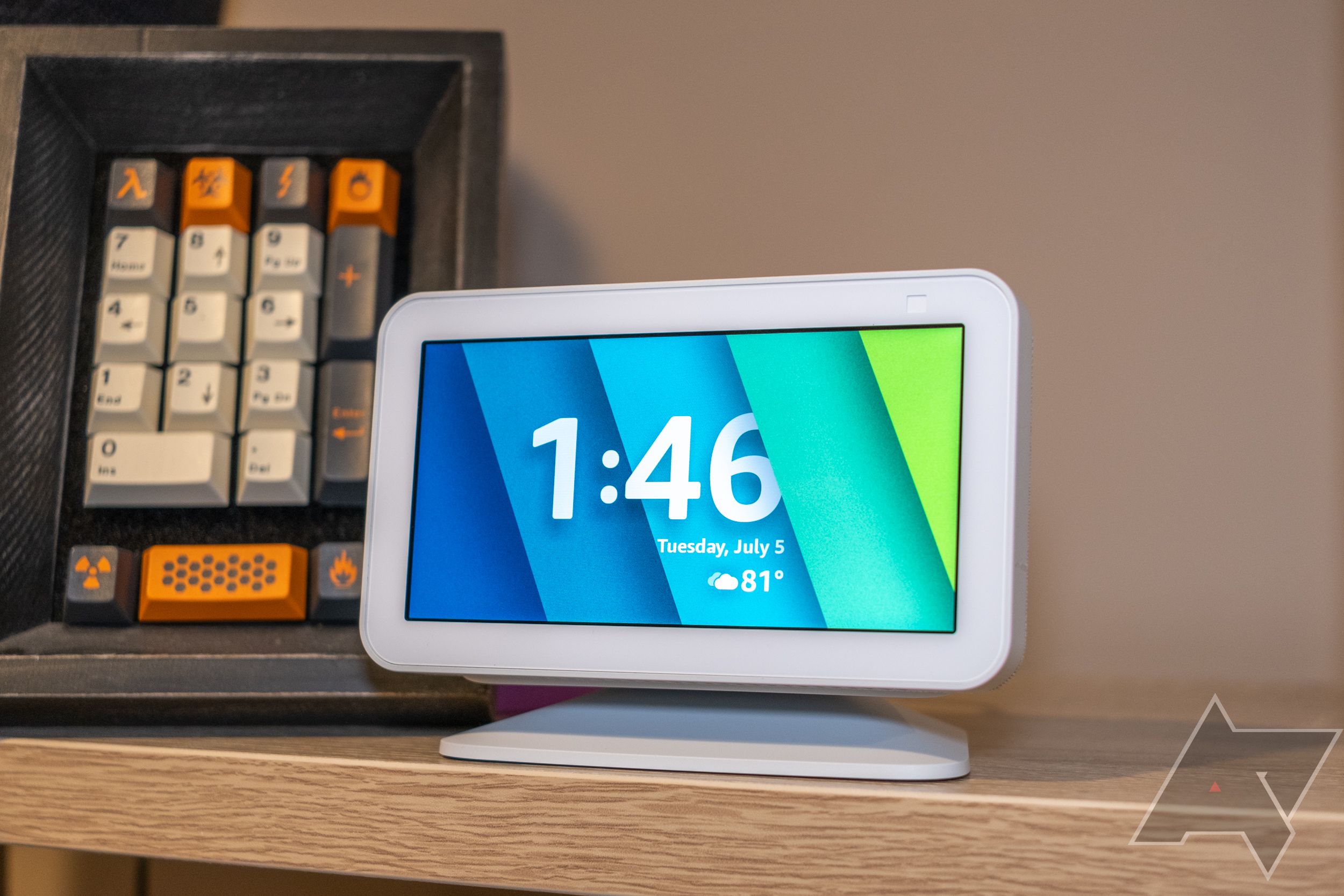 alexa echo display device resting on wooden shelf 