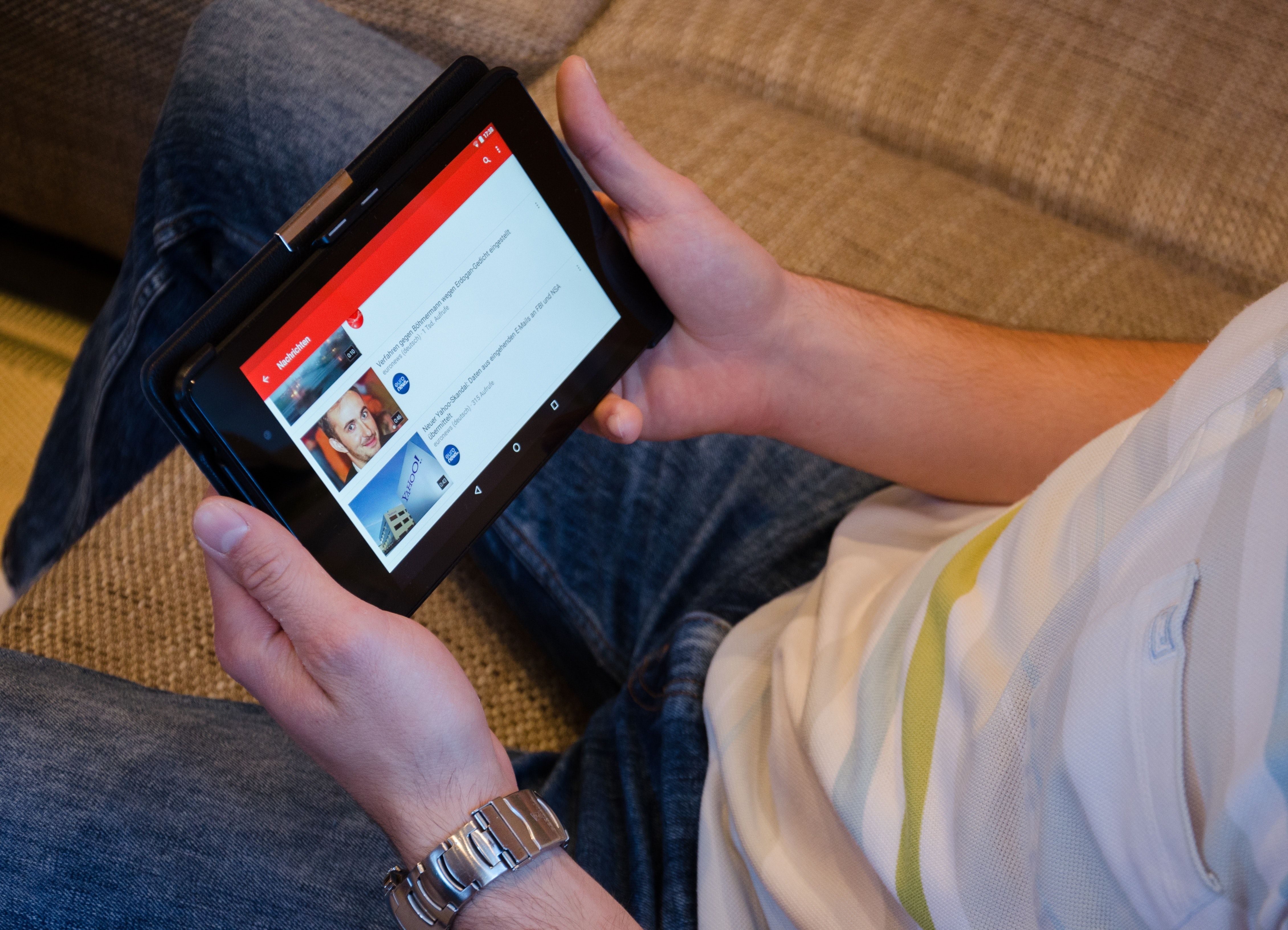 Person watching YouTube on tablet