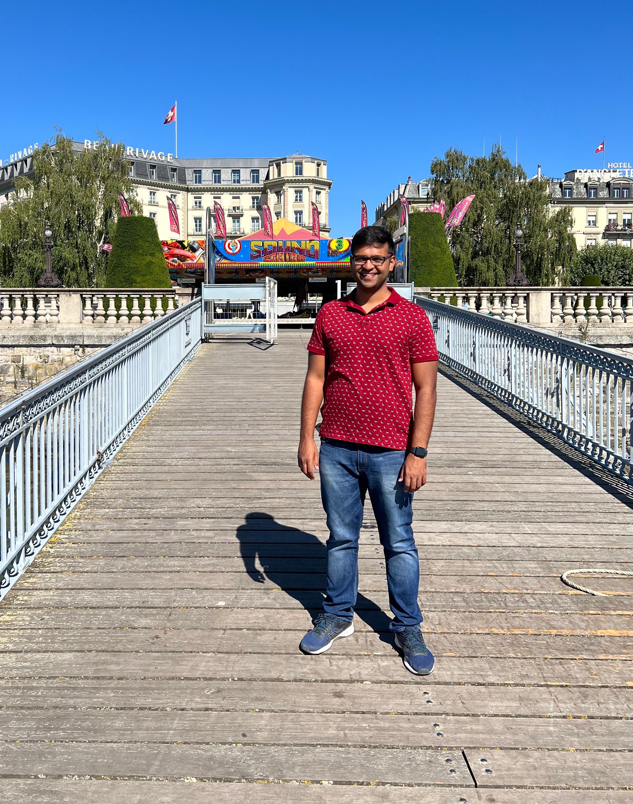 A person standing on a dock with a city behind them