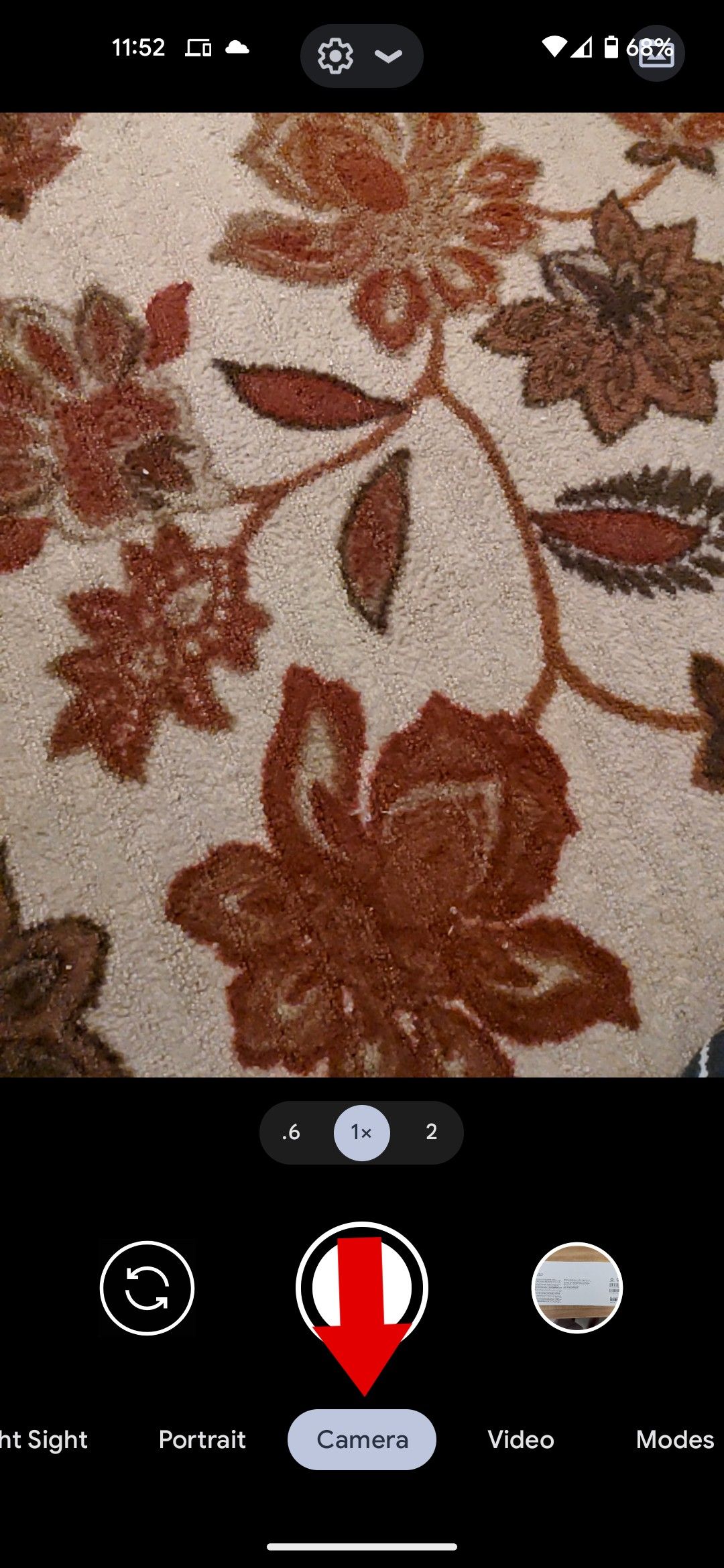 The Google camera app with a red arrow pointing to the camera mode selector.