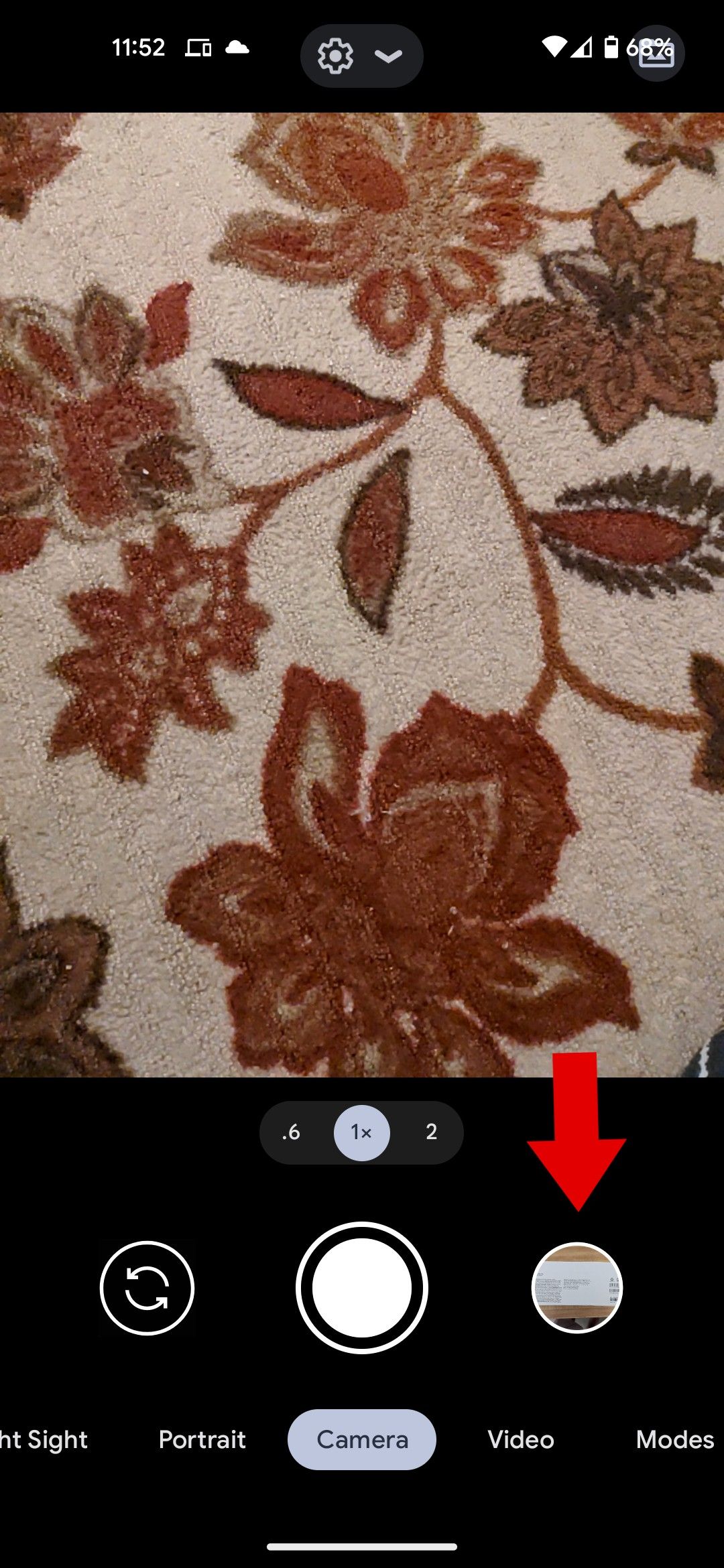 The Google camera app with a red arrow pointing to the photo library.