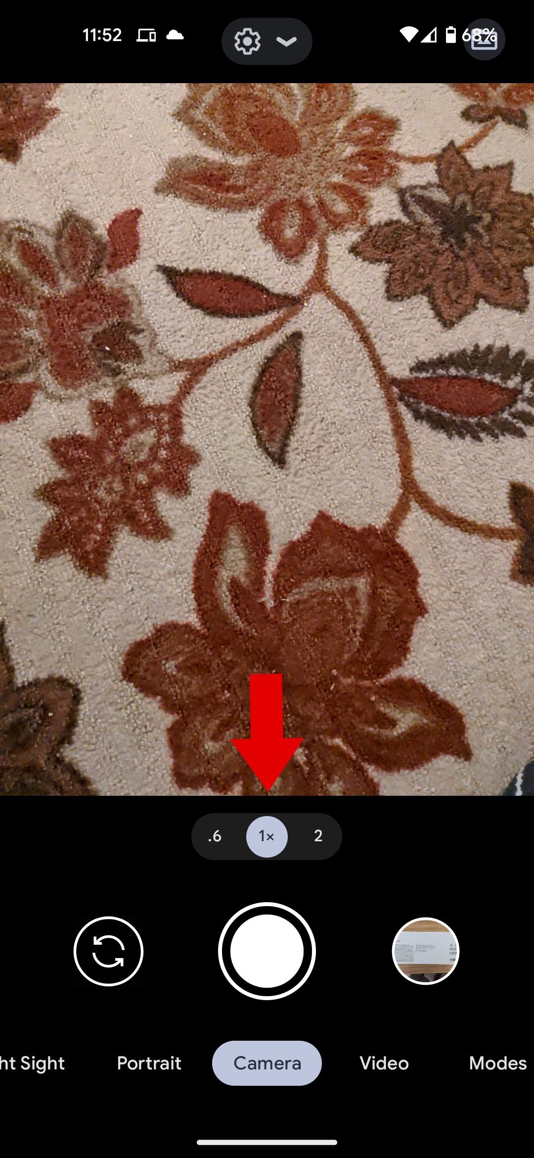 The Google camera app with a red arrow pointing to the zoom toggle.