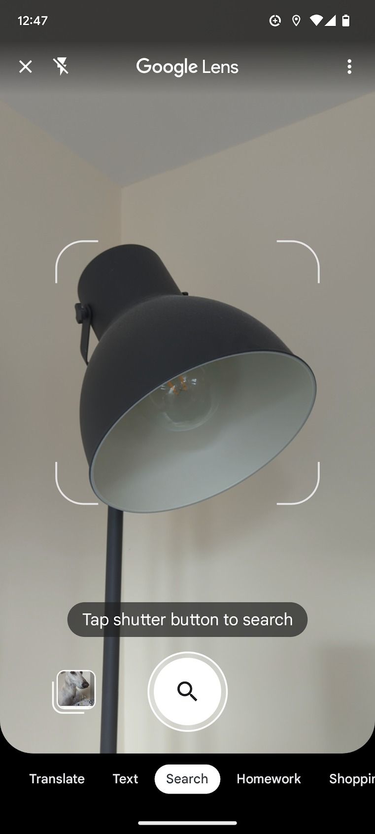A screenshot of the Google Lens app is displayed, with the camera viewfinder focused on scanning a lamp.