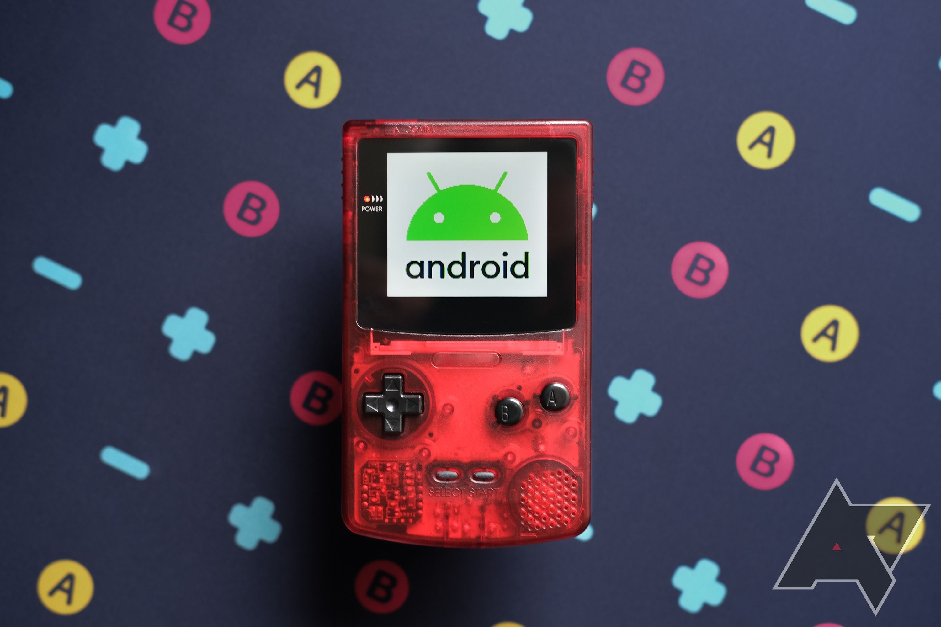 A retro handheld game console with 'Android' displayed on the screen