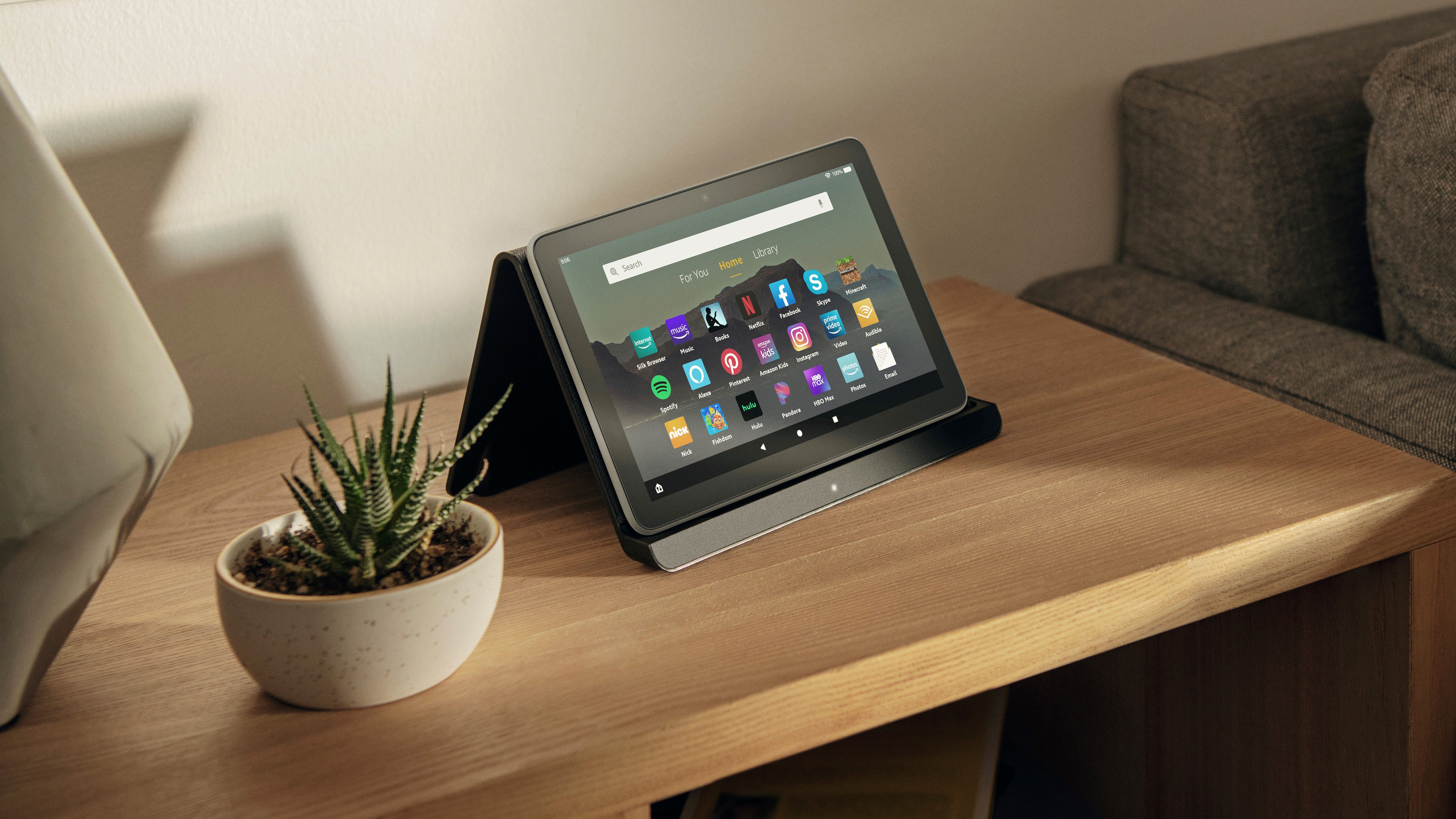 A tablet sits in tent mode on a wooden table.