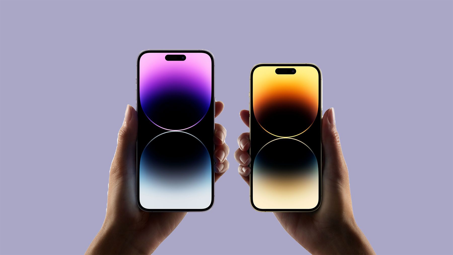 A person holds two smartphones with illuminated screens in front of a purple background