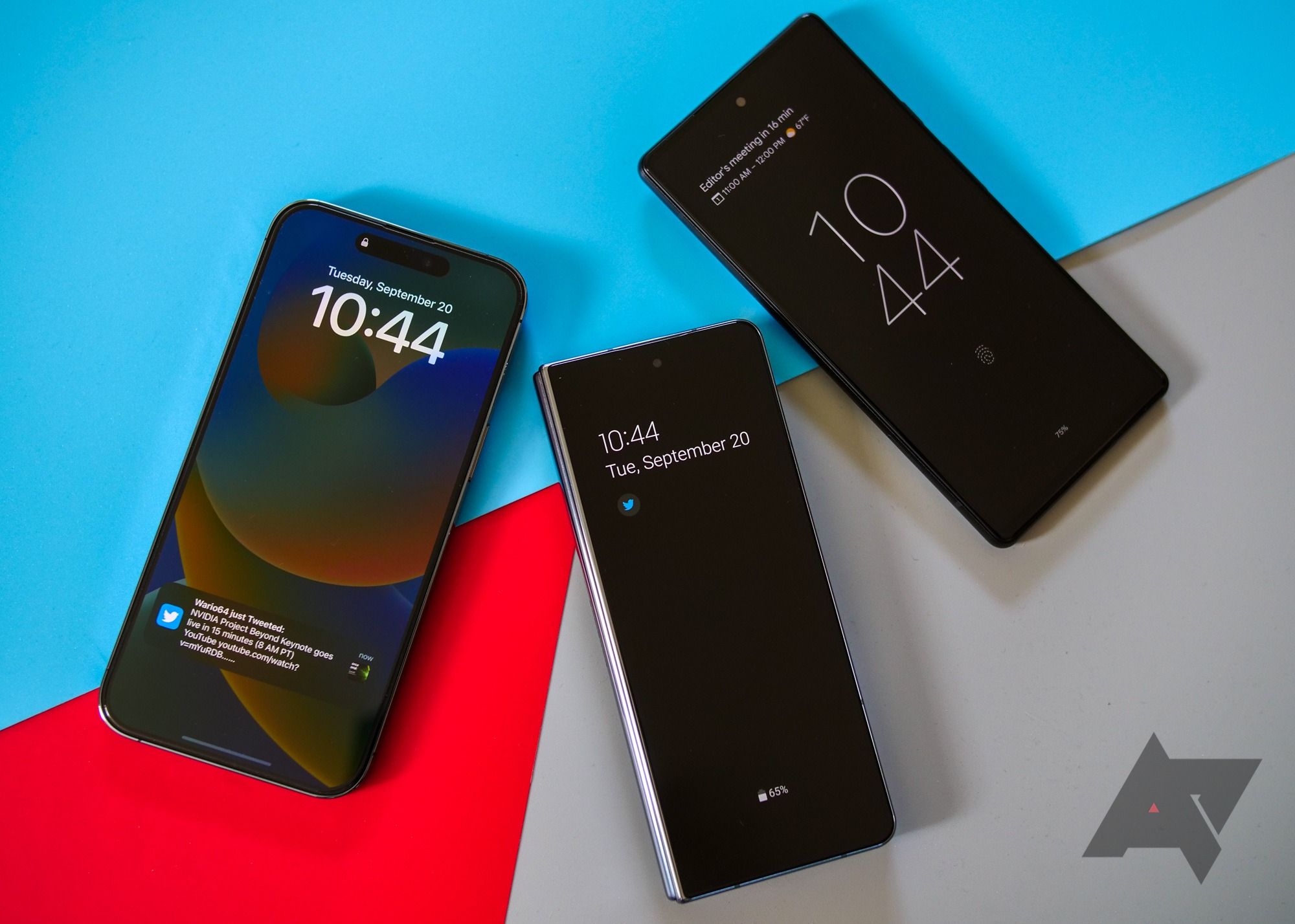 An iPhone 14 Pro Max, a Samsung Galaxy Z Fold 4, and a Pixel 6 all next to each other on a colored backdrop.