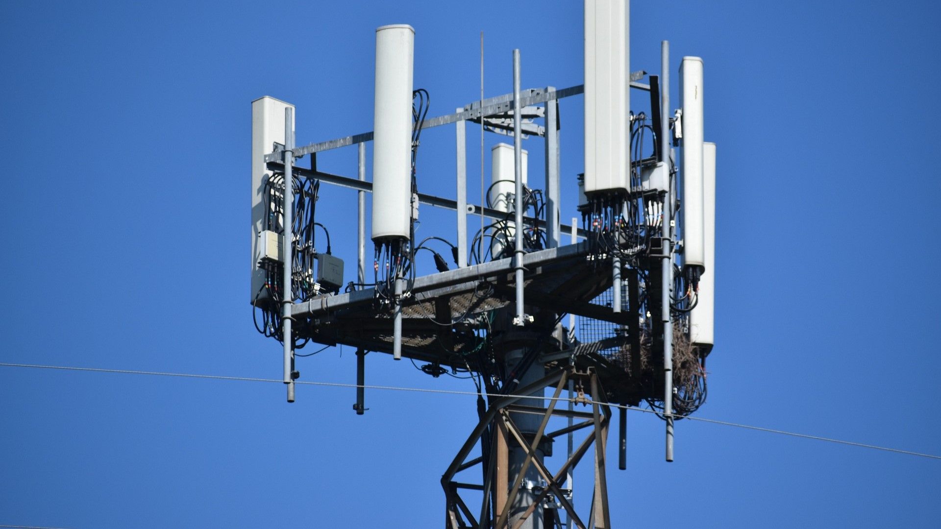 An example image of what a cell tower might look like with a blue sky background