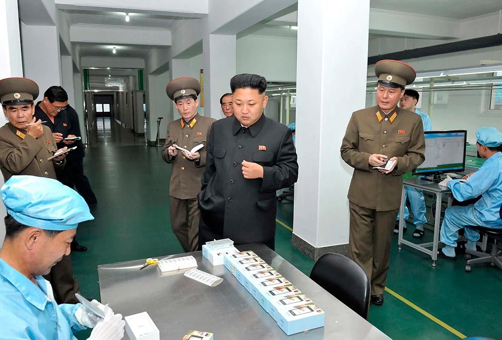 kim jong un with soliders in factory