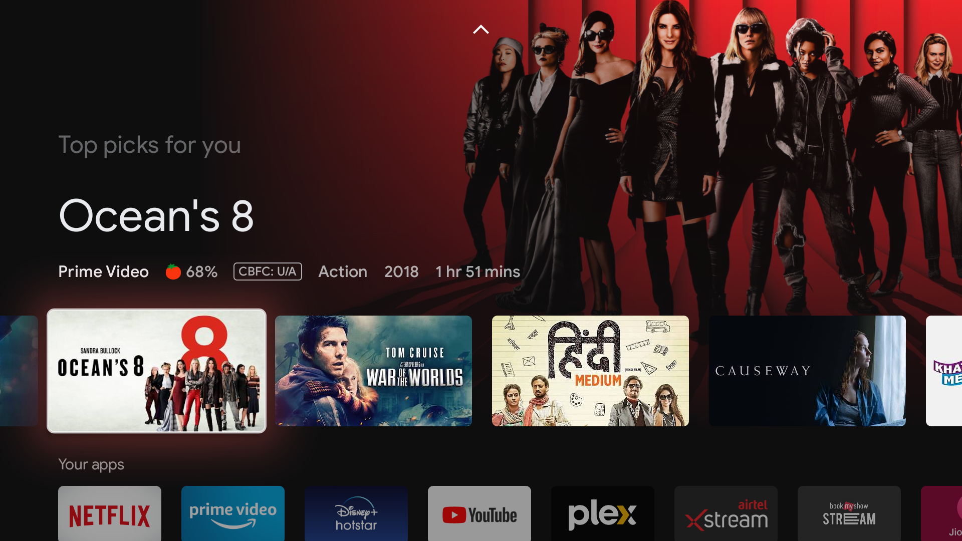 Google TV screen render showing Ocean's 8 key art and various other films and streaming platforms in a grid.