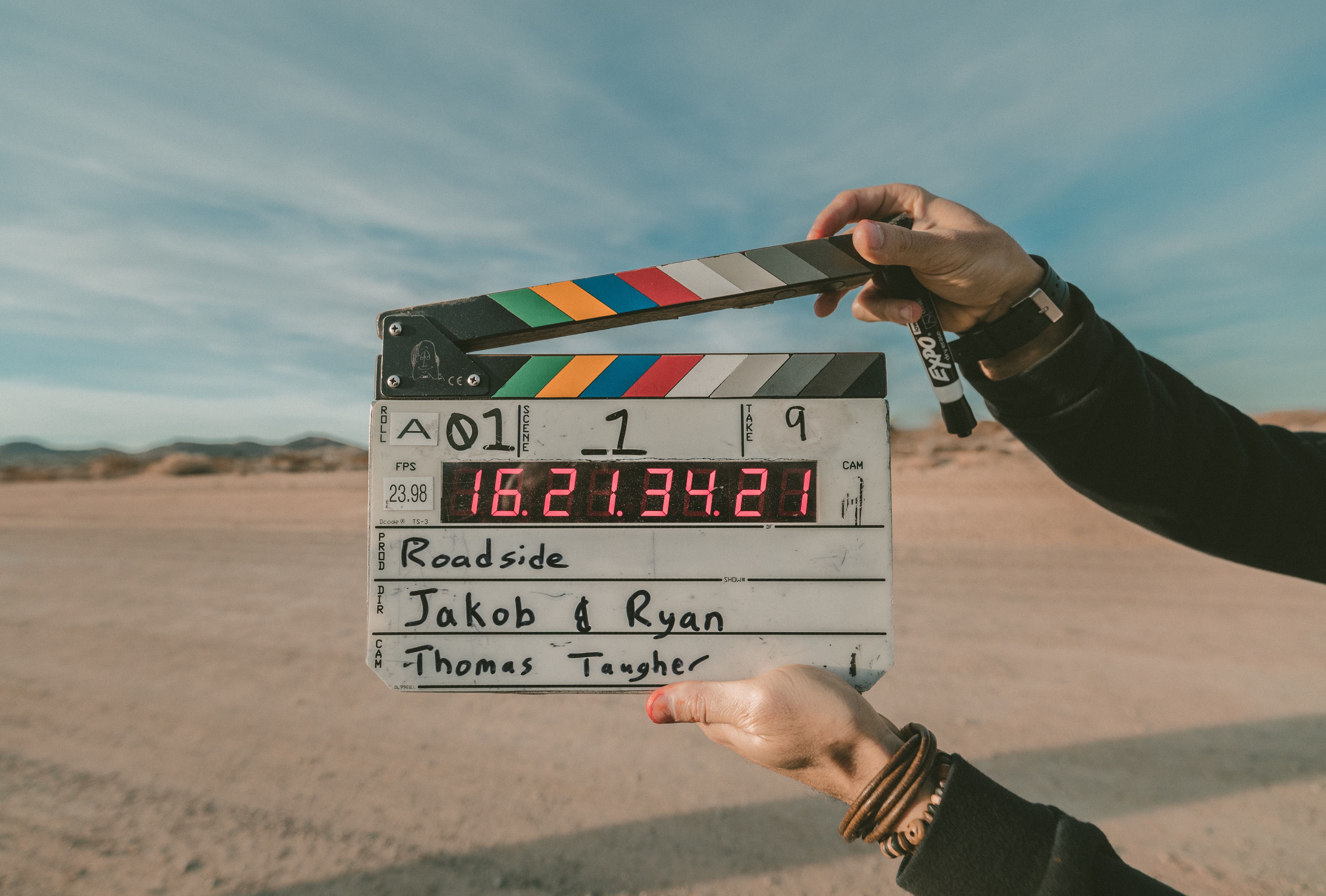 Hands holding a clapperboard