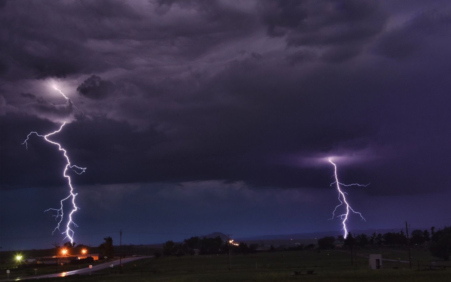 A dark sky with lightening bolts between the clouds and the ground.