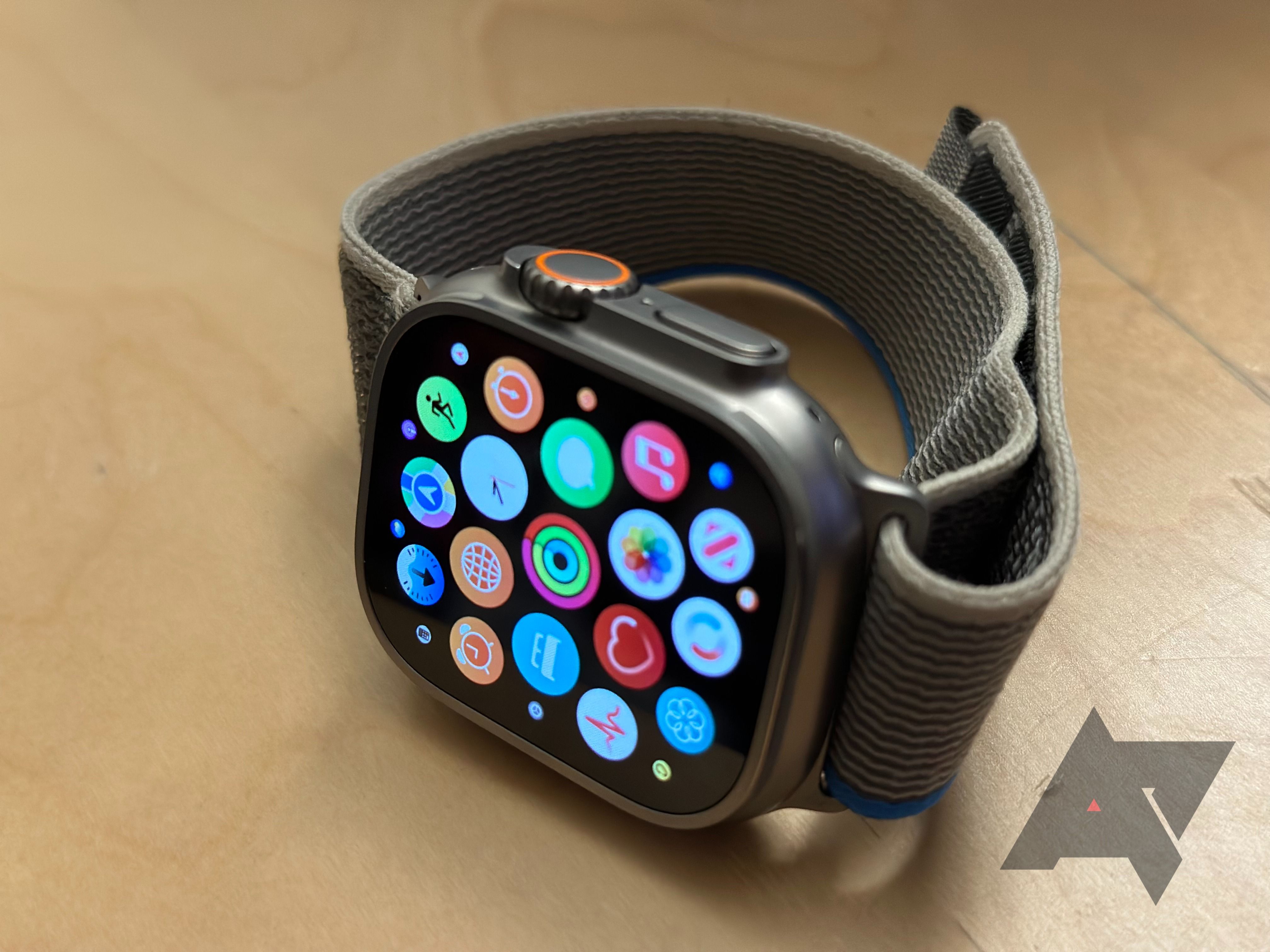 the Apple Watch Ultra on its side, with the display showing an app grid.