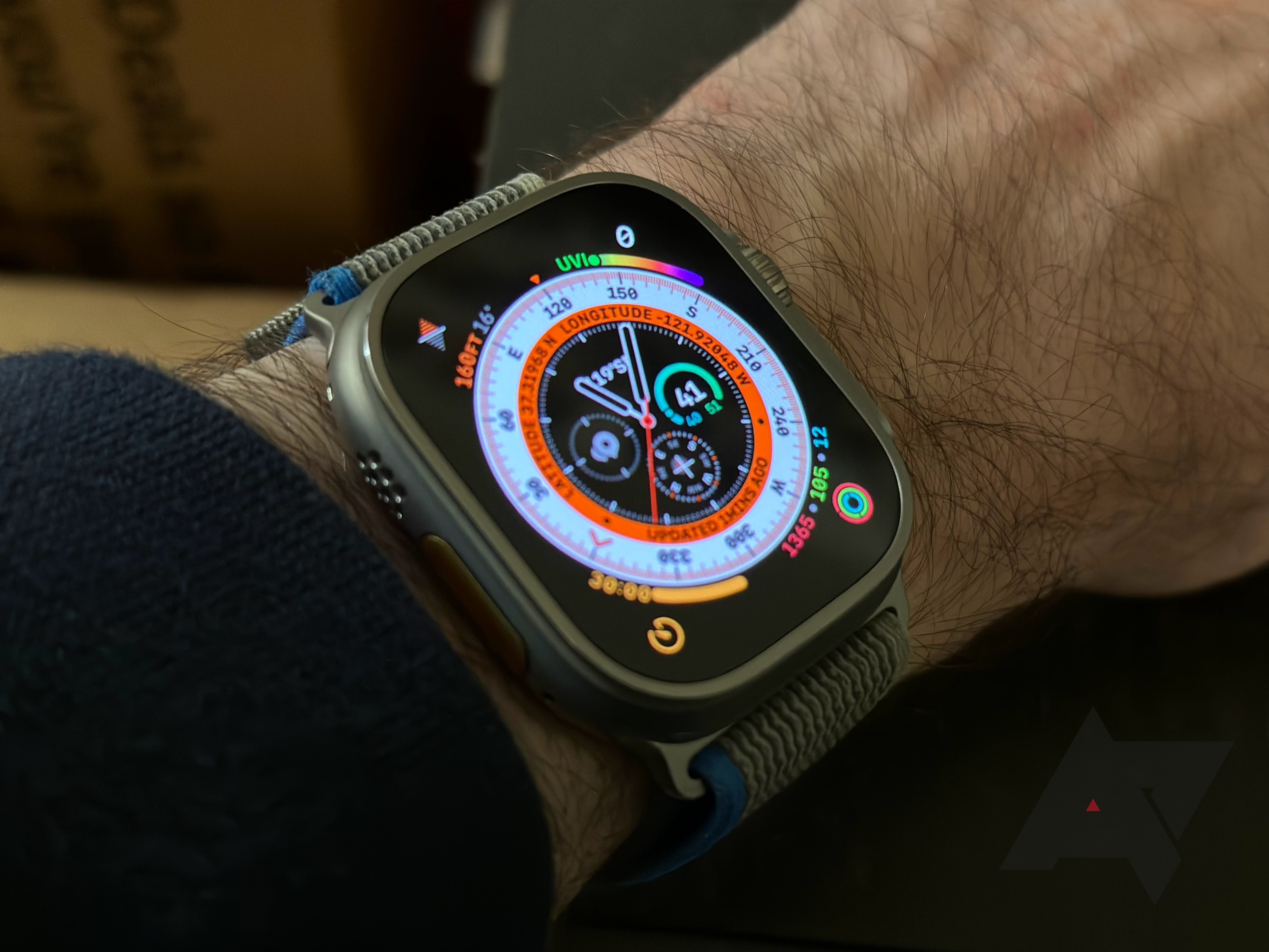 An Apple Watch Ultra on a wrist with a colorful watch face showing.