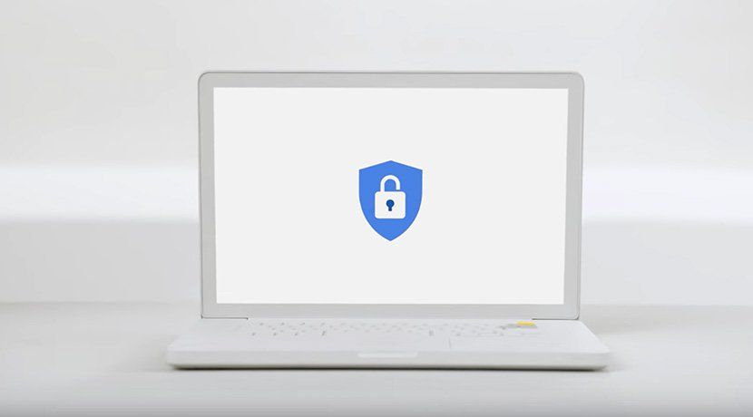 A white laptop sits on a white table.  The Google Advanced Protection Program logo is on the laptop screen
