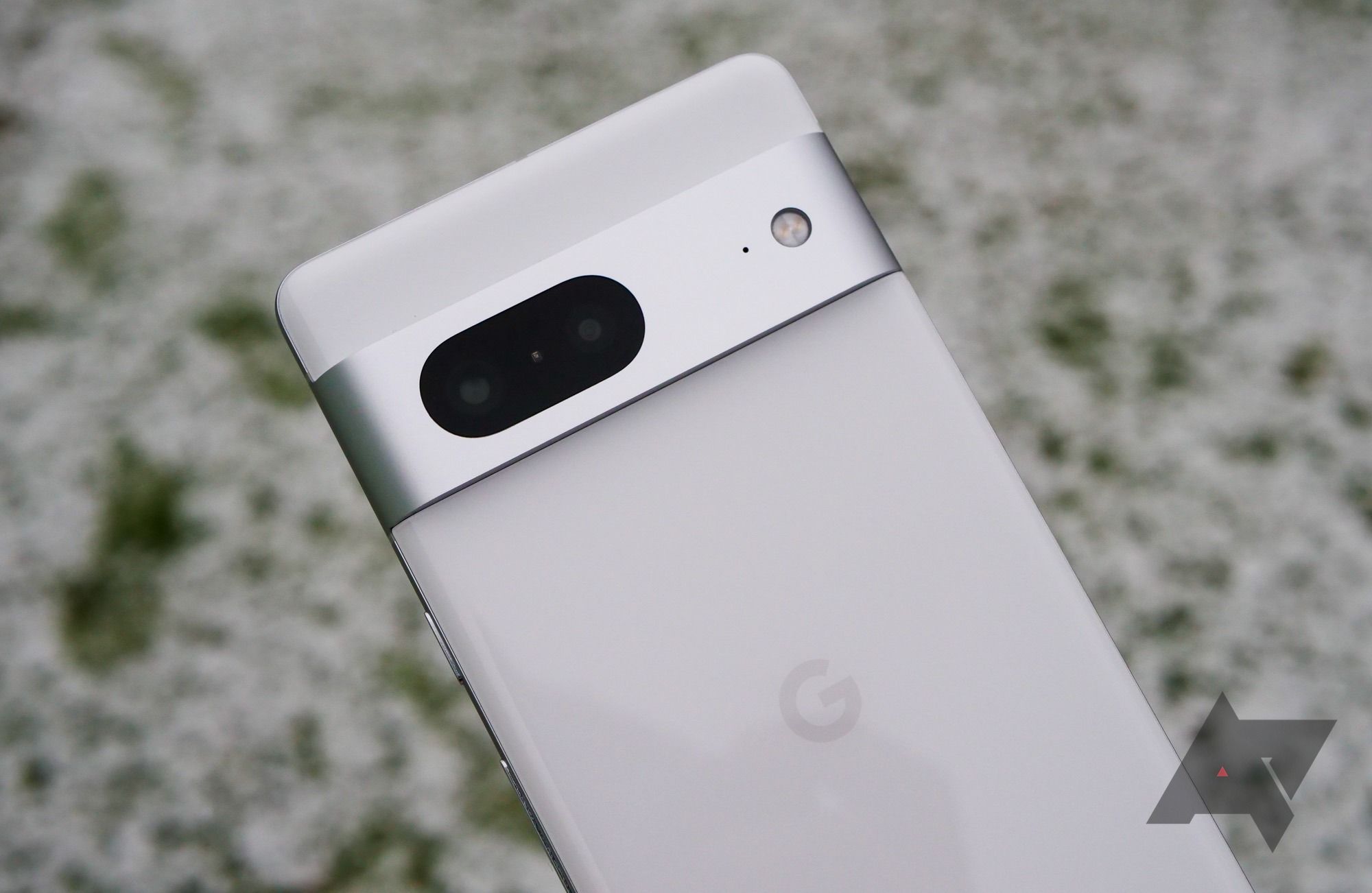 A white Google Pixel phone with the Google logo in gray and a horizontal metal camera bar. 