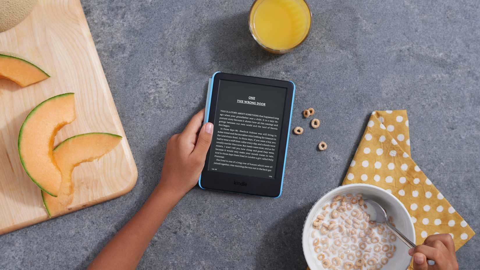 Amazon Kindle Kids 2022 set on a kitchen counter as someone reads while eating cereal