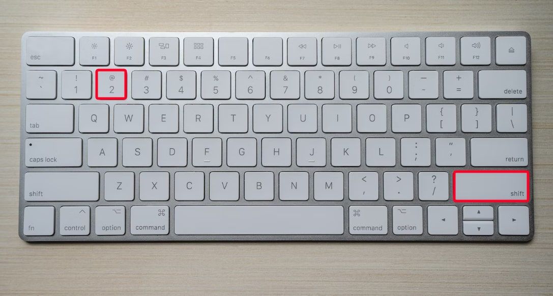 White computer keyboard showing the Shift+2 keyboard shortcut