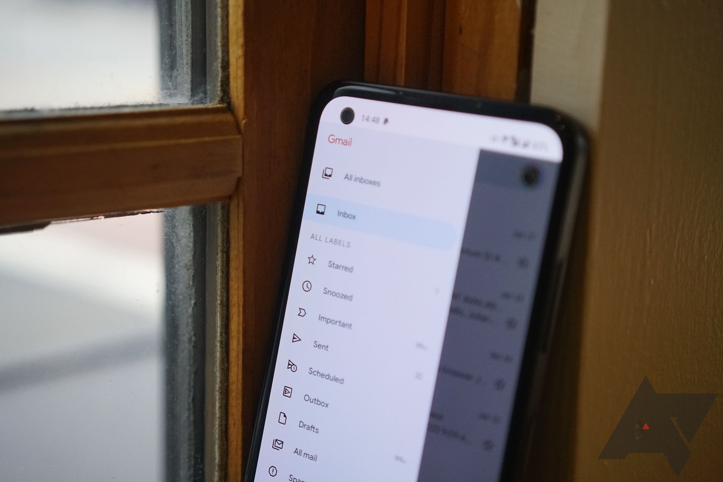 A smartphone rests against a windowsill. 