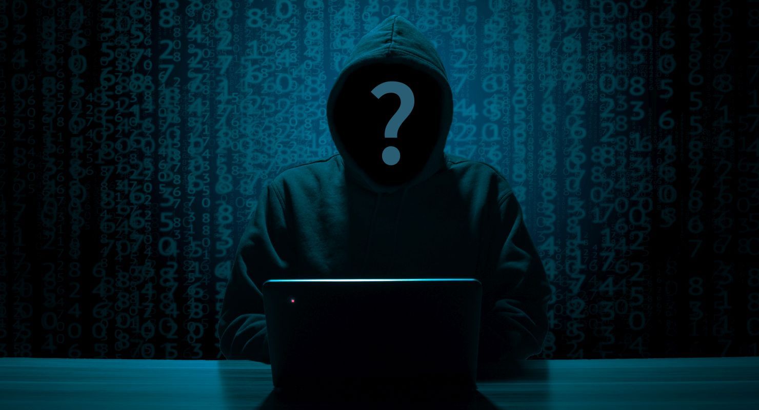 Hacker on a computer in a dark room