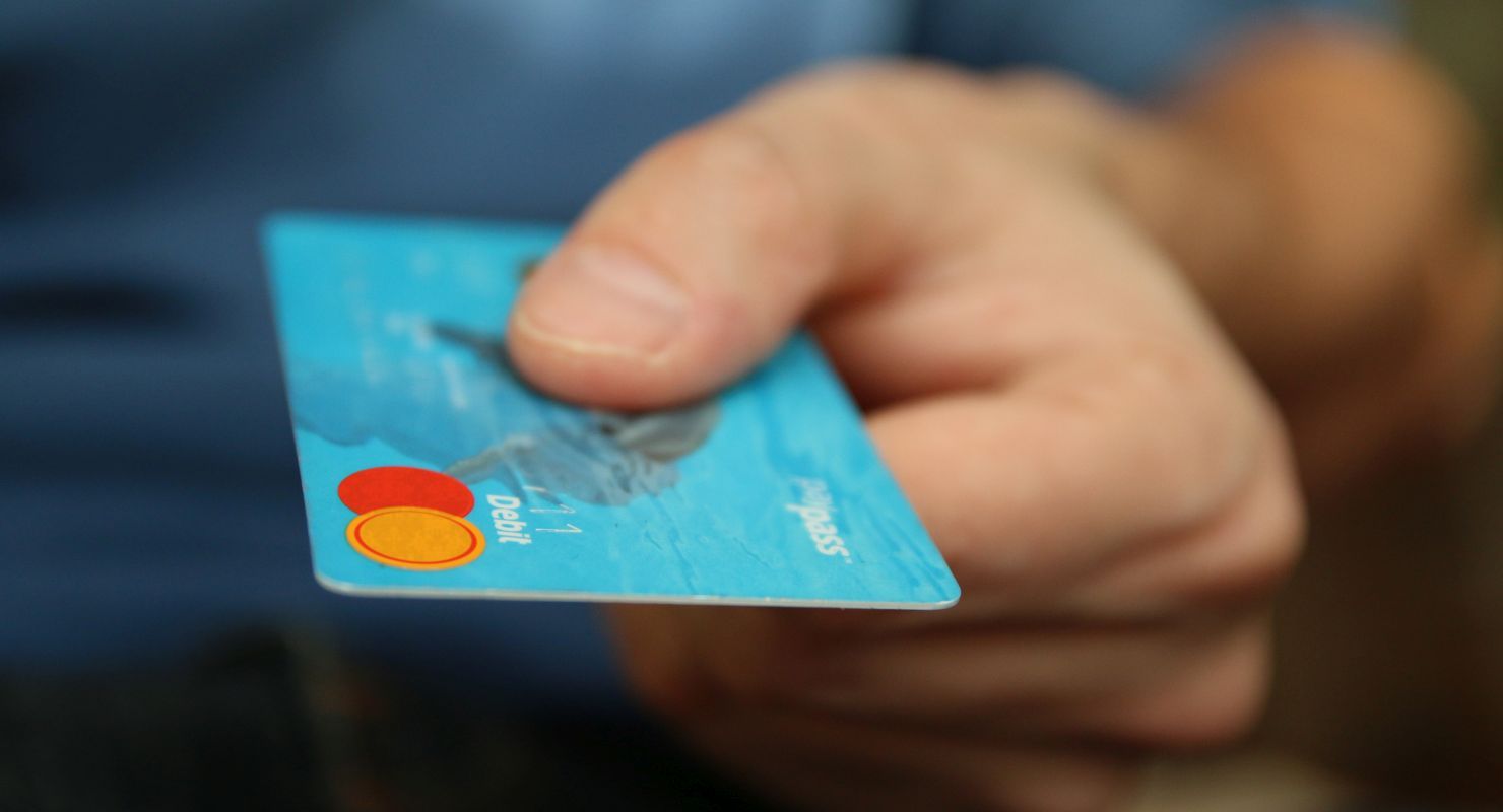 hand holding a debit card