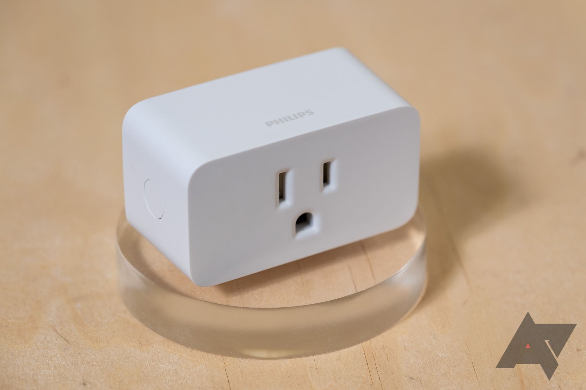 A Phillips Hue smart plug sitting on a table top