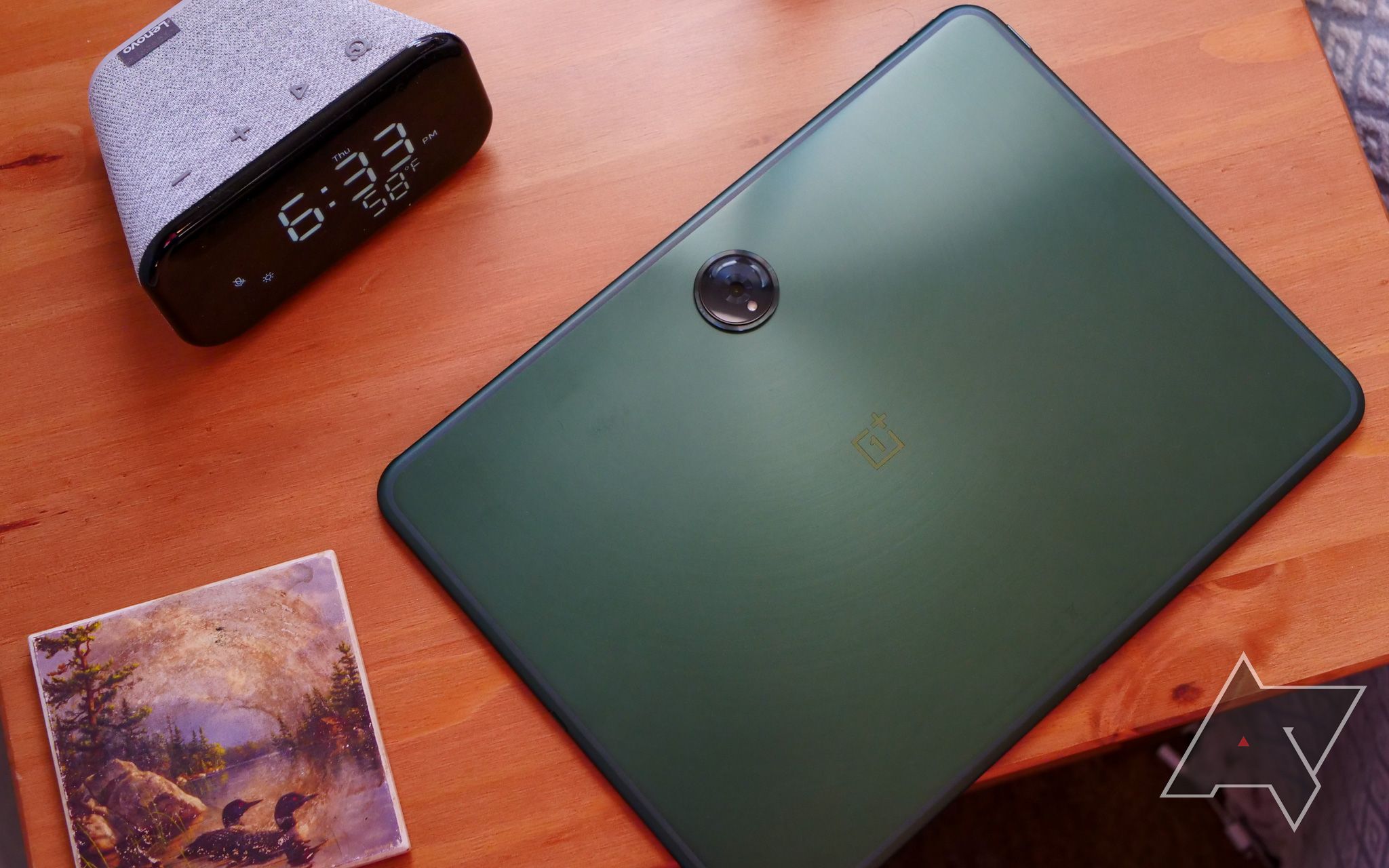 A green tablet sitting face-down on a table